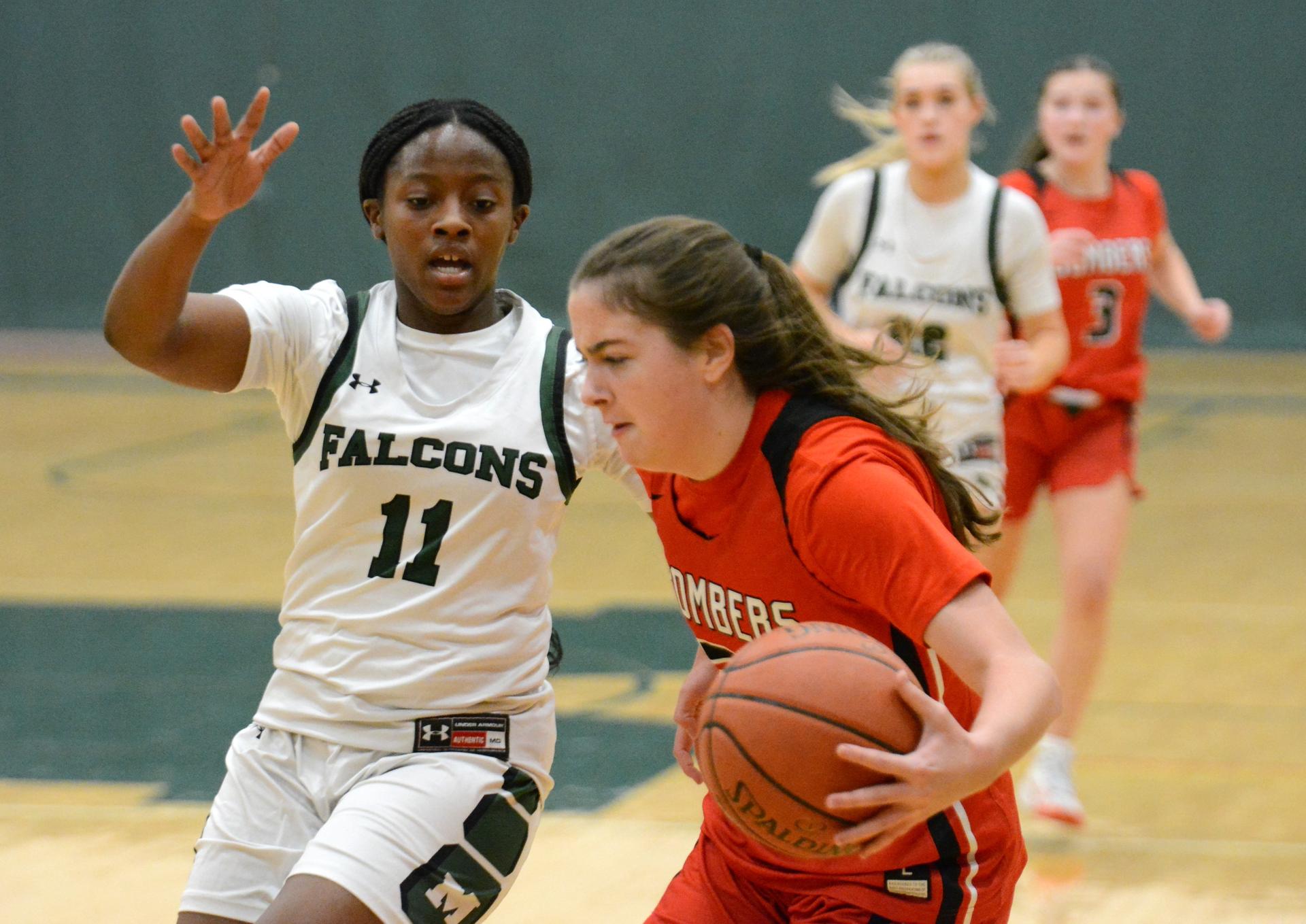 Kayakers on the water pass a rock formation