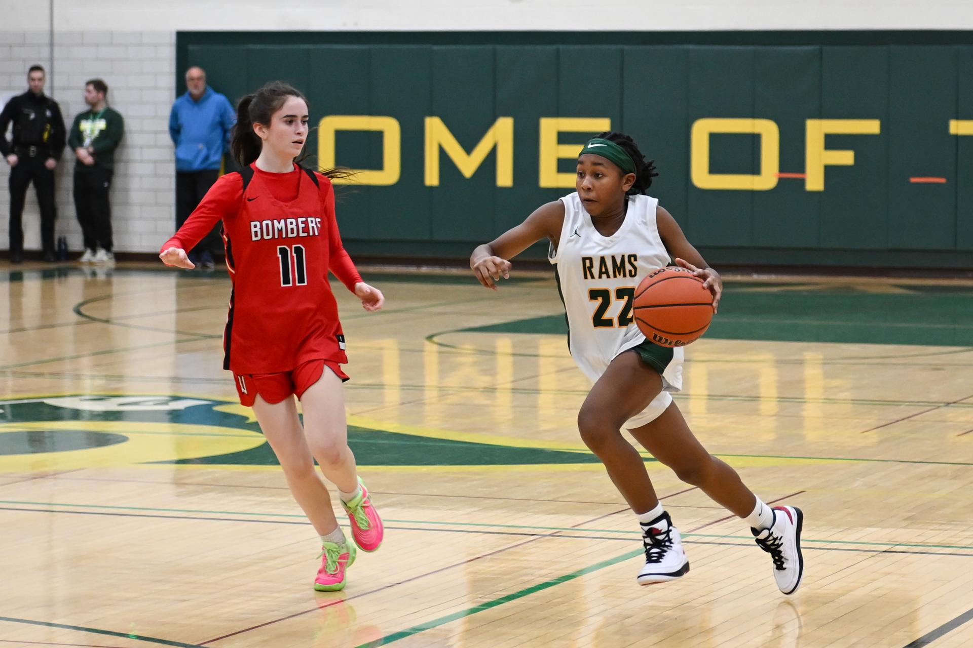 Kayakers on the water pass a rock formation