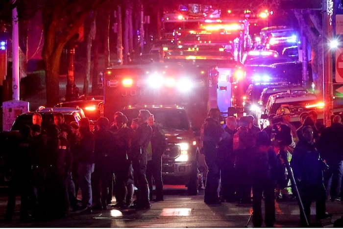 Emergency personnel gather at Brown University on Saturday after a shooting in a lecture hall that killed at least two students. Mark Stockwell/AP