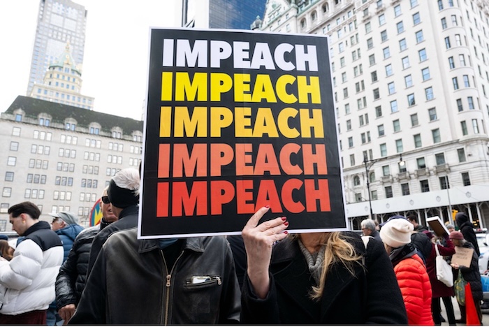 A protester with a sign saying 