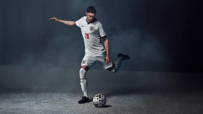 An illustration of Cole Palmer, a soccer player wearing the English national team jersey with the number 20. He is sharing to kick a soccer ball with his left foot.