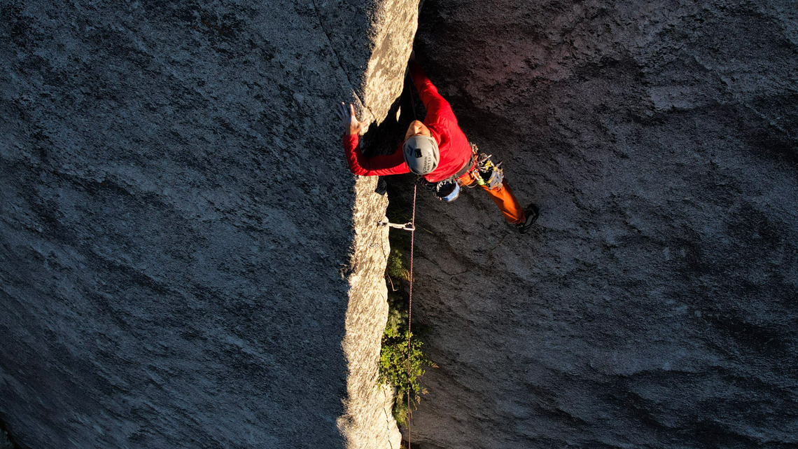 Aaron Mike ascends a dihedral crack in Idaho’s Sawtooth Wilderness using removable trad gear climbing towards a fixed anchor. There were already many permanent anchors in wilderness areas before the PARC Act clarified that they were officially allowed.