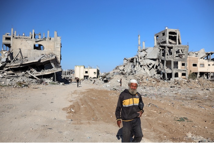 A Palestinian man walks past the rubble of destroyed buildings in the Al-Tuffah neighborhood near Gaza City on Tuesday. Photo by Majdi Fathi/NurPhoto via AP