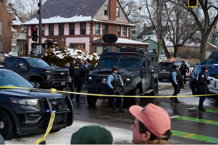 Law enforcement officers secure the scene in Minneapolis where an ICE agent fatally shot Renee Nichol Good, a 37-year-old mother. Christian Zander/NurPhoto via AP