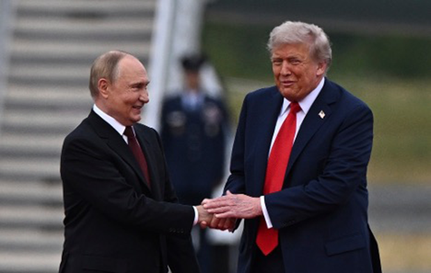 President Donald Trump greets Vladimir Putin on the tarmac at Joint Base Elmendorf-Richardson in Anchorage, Alaska, on August 15, 2025. Sergey Bobylev/Sputnik via AP