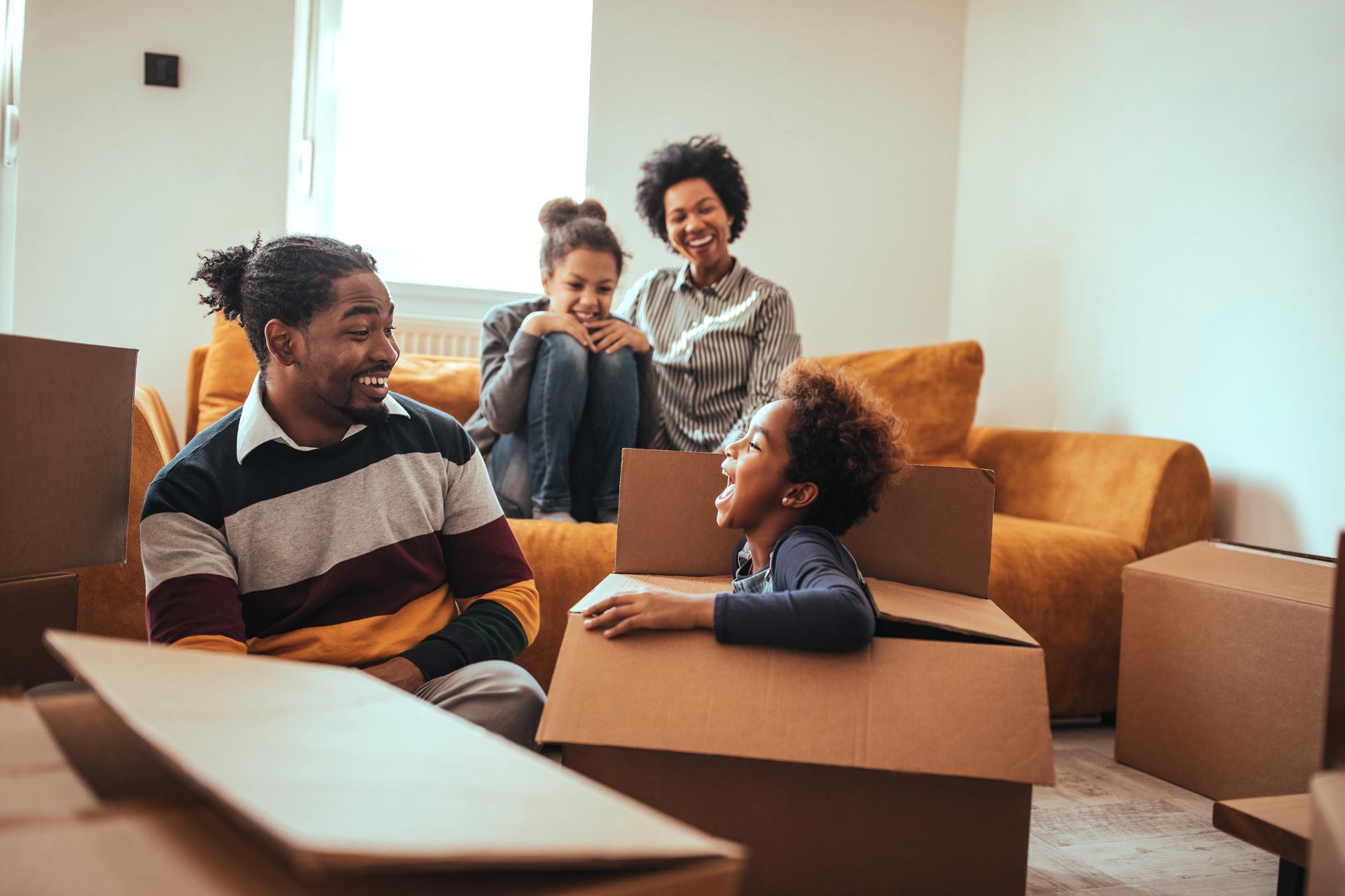 A family moving into a new house, playing with the boxes.