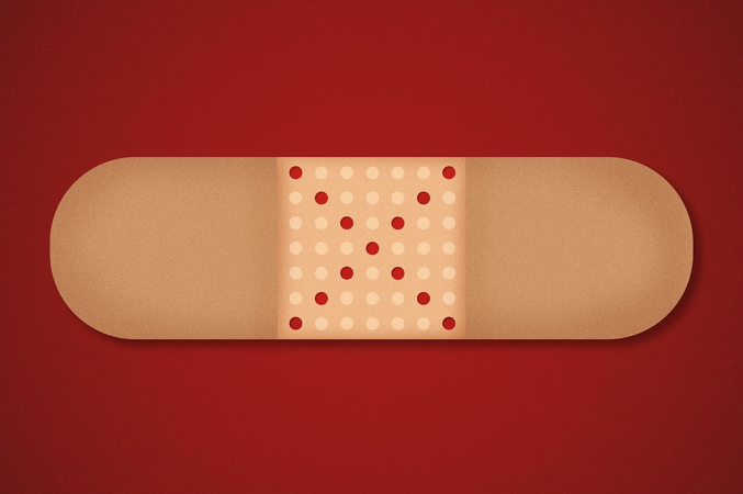 Red dots form an X in the middle of a bandage.