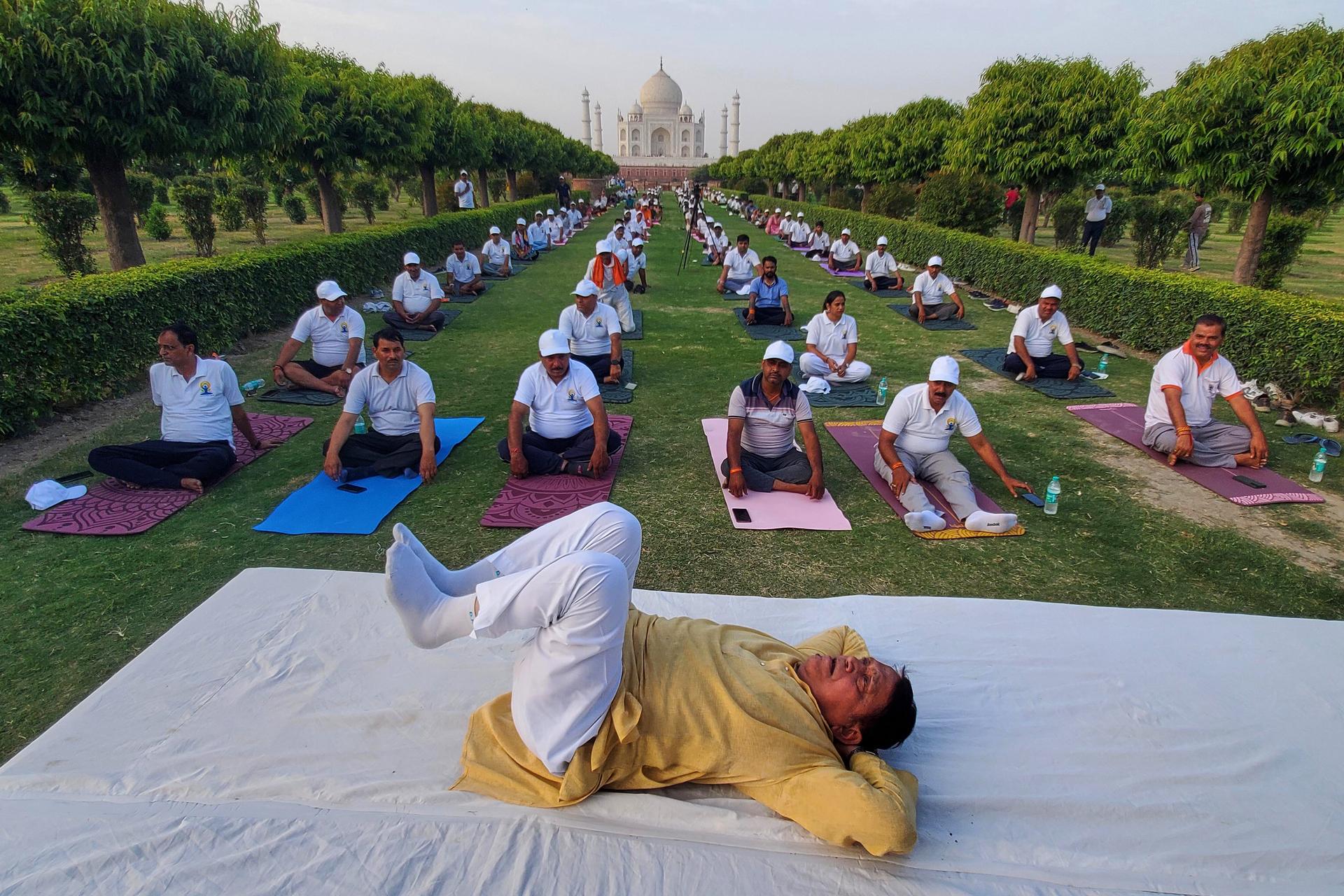 People perform yoga during an International Yoga Day event against the backdrop of the Taj Mahal in Agra, India, on Sunday. (AP Photo/ Pawan Sharma)