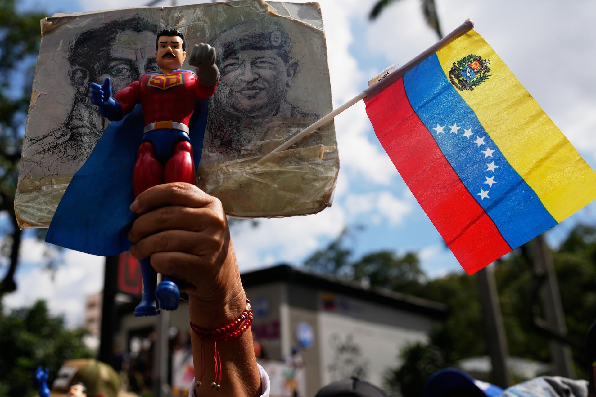 A government supporter holds an action figure of Super Bigote during a protest Sunday, demanding the release of President Nicolás Maduro, who was captured by U.S. forces, in Caracas, Venezuela.