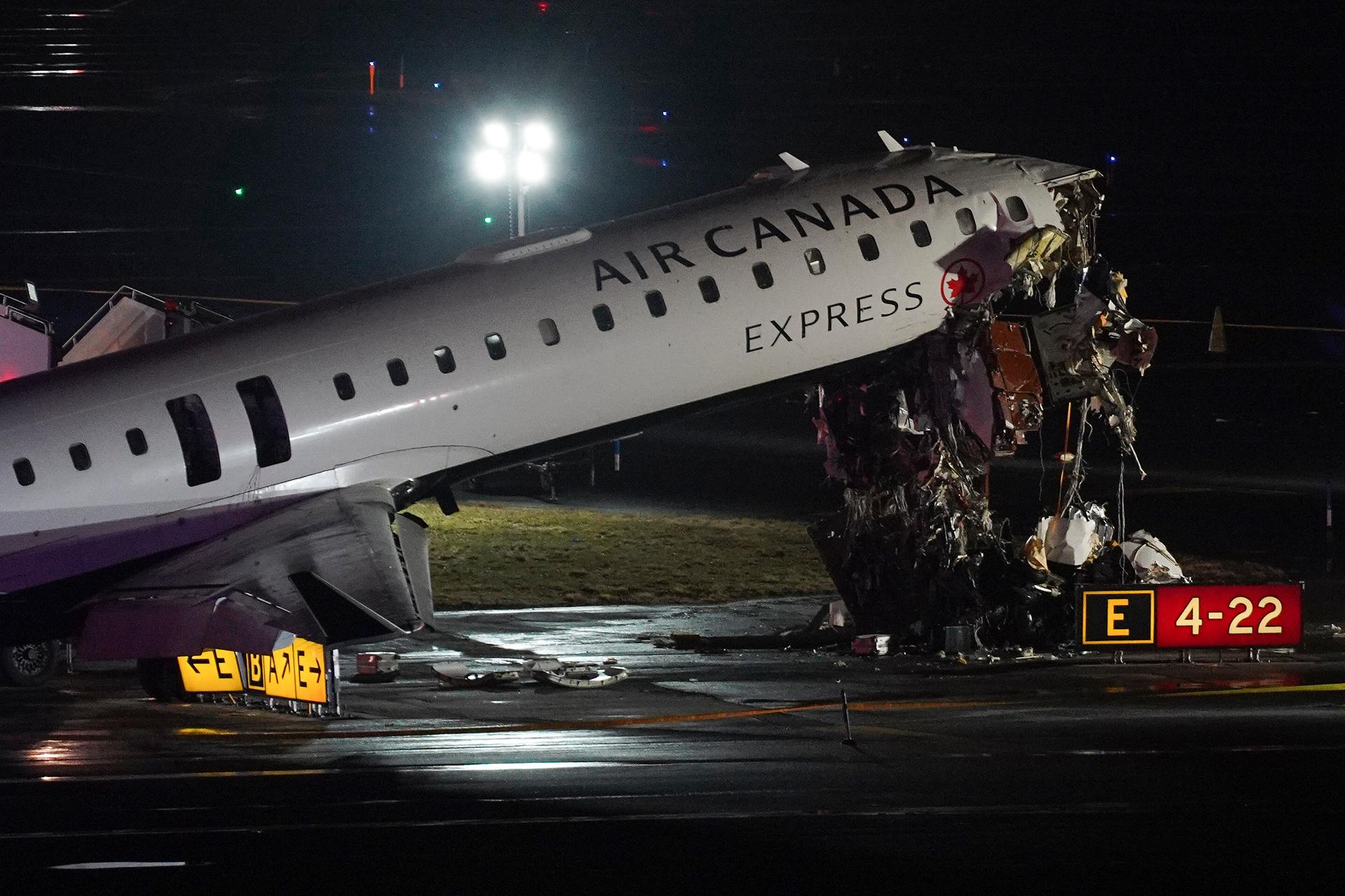 An Air Canada Jet sits on the runway at LaGuardia Airport, Monday, after colliding with a Port Authority aircraft rescue and firefighting vehicle after landing in New York.