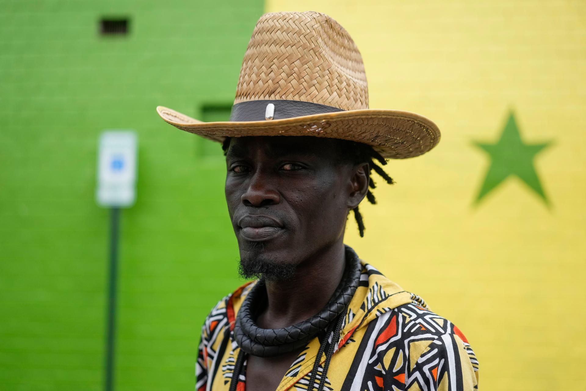 Mohamed, a Senegalese immigrant, pauses as he walks through the parking lot of Touba Tedoungal African Restaurant, July 31, in Lockland, Ohio. 