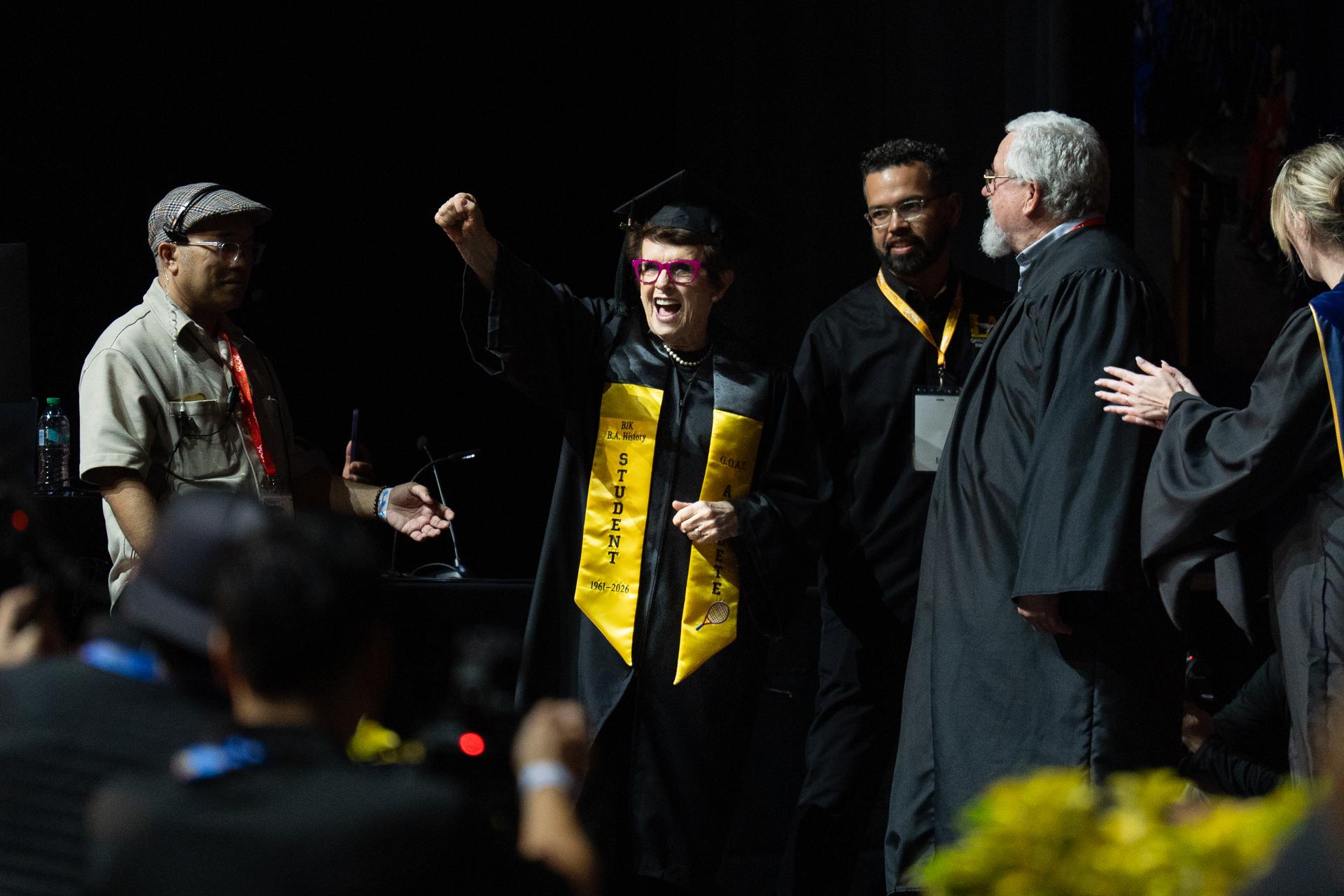 Tennis legend Billie Jean King raises her fist after being called to receive her diploma during California State University, Los Angeles, commencement on Monday. (AP Photo/Jae C. Hong)