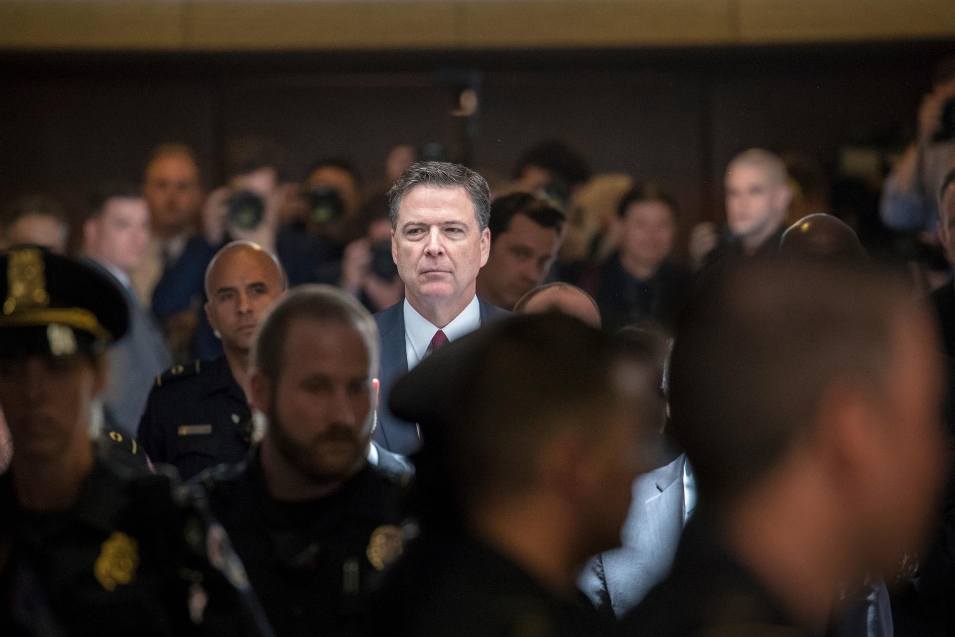 Former FBI director James Comey on the way to a secure room to continue his testimony to the Senate Select Committee on Intelligence, on Capitol Hill in Washington, June 8, 2017.