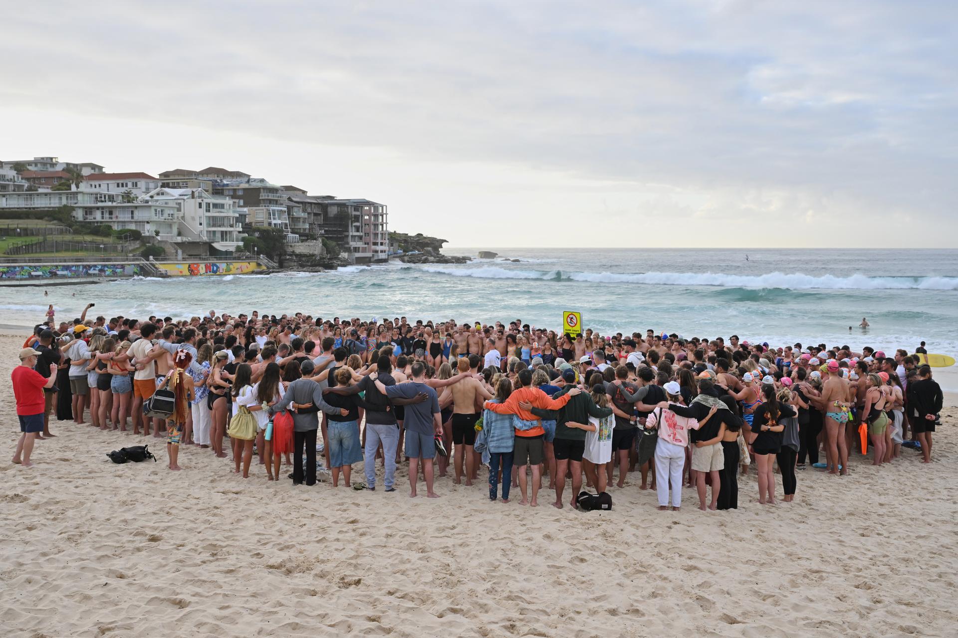 Swimmers gather for a morning vigil in Sydney on Wednesday. (Mick Tsikas/AAP Image via AP)
