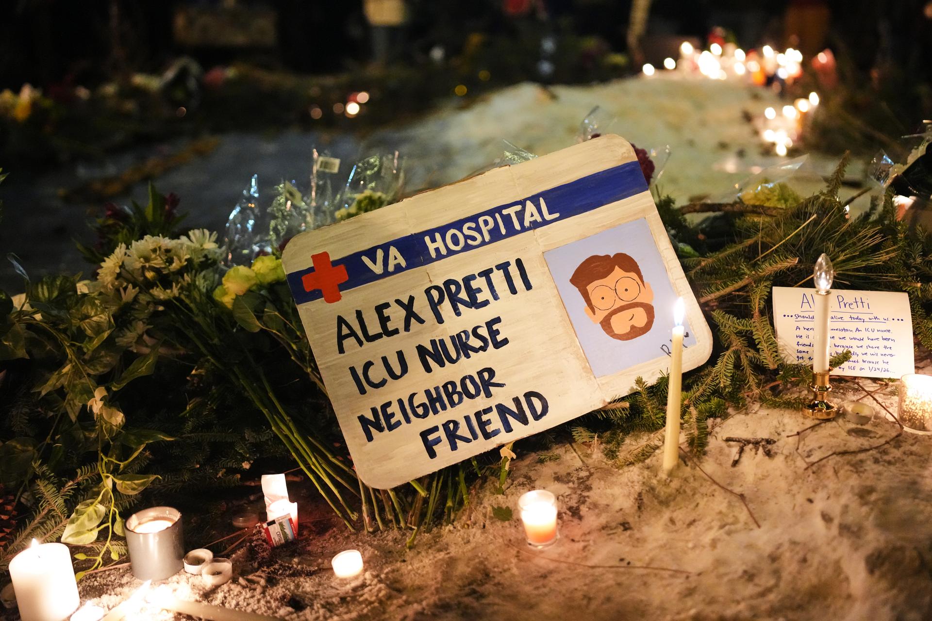 A sign for 37-year-old Alex Pretti, who was fatally shot by a U.S. Border Patrol officer earlier in the day, is displayed during a vigil in Minneapolis on Saturday. (AP Photo/Adam Gray)