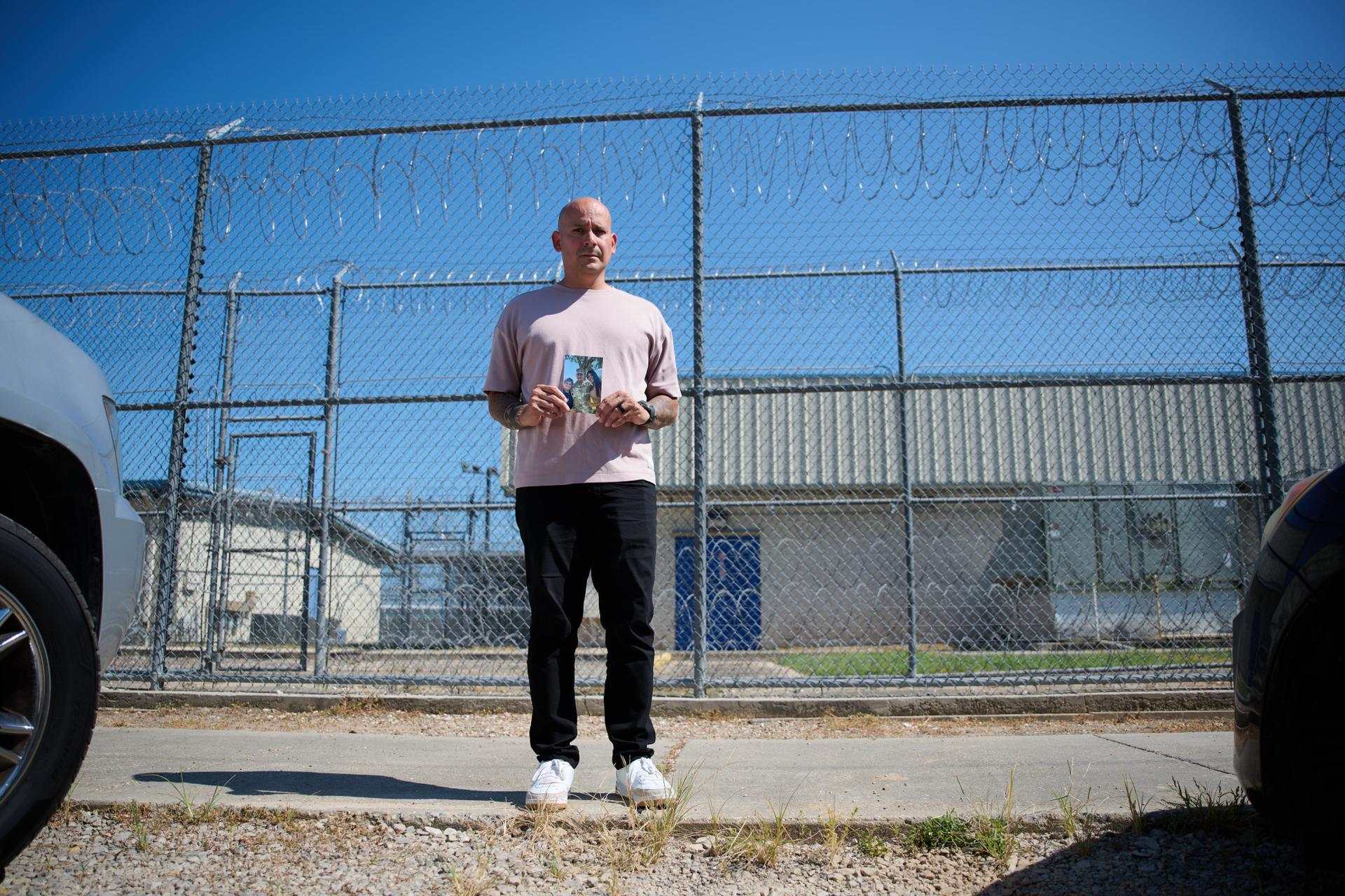 Army Staff Sgt. Alexis Jaramillo poses with a photo of his wife, Maisa Lopes Eliaser, a Brazilian national who is being detained by ICE, before visiting her at the South Louisiana ICE Processing Center in Basile, La., Sunday.
