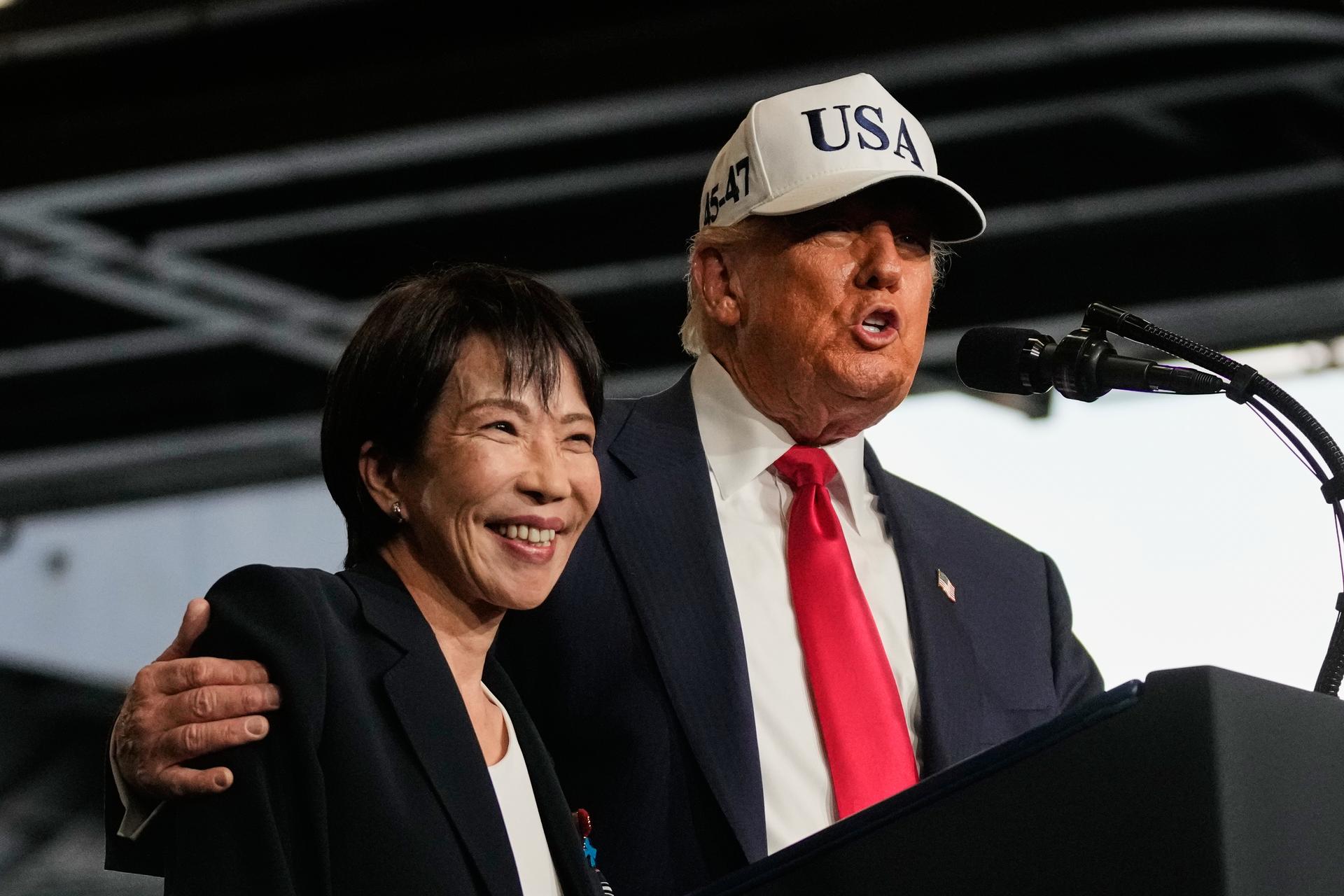 President Donald Trump, with Japanese Prime Minister Sanae Takaichi, speaks to members of the military aboard the USS George Washington, an aircraft carrier docked at an American naval base, in Yokosuka.