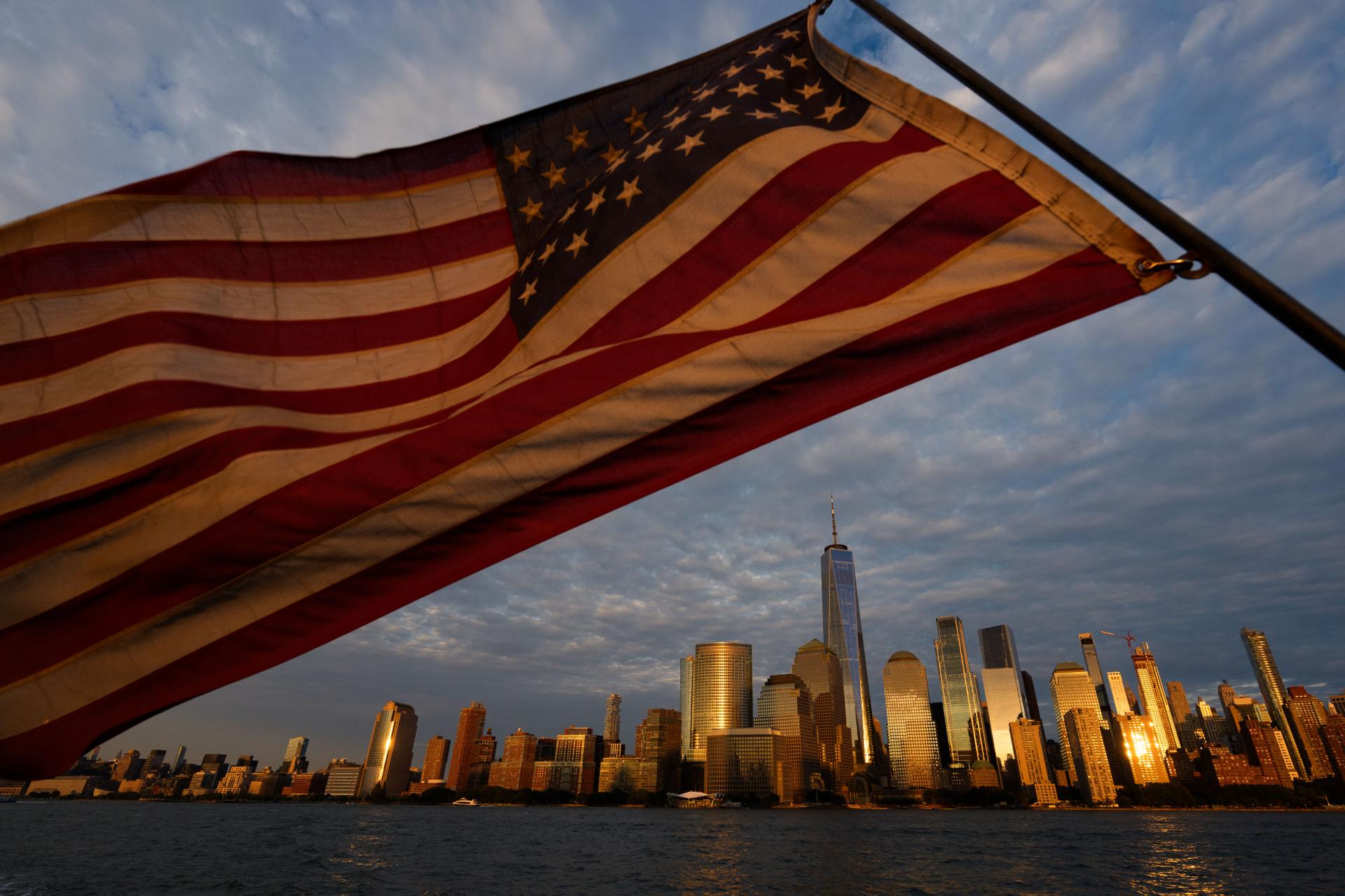 An American flag flies, with the lower Manhattan skyline in background, Wednesday, in Jersey City, NJ. 