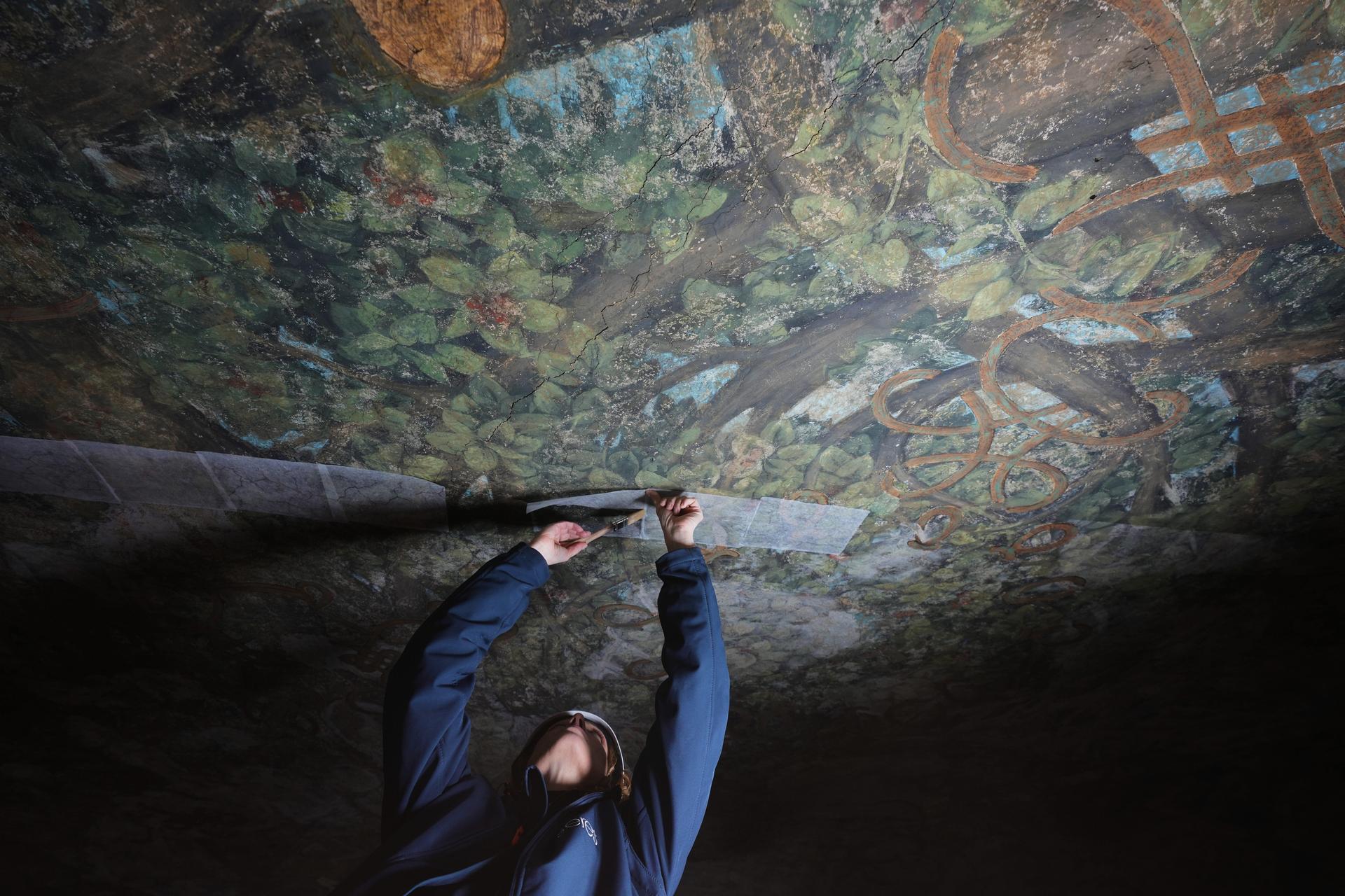 Stefania Negro works on restoring the Sala delle Asse, part of the newly created Leonardo da Vinci itineraries inside Milan's Sforza Castle, Italy, Tuesday.