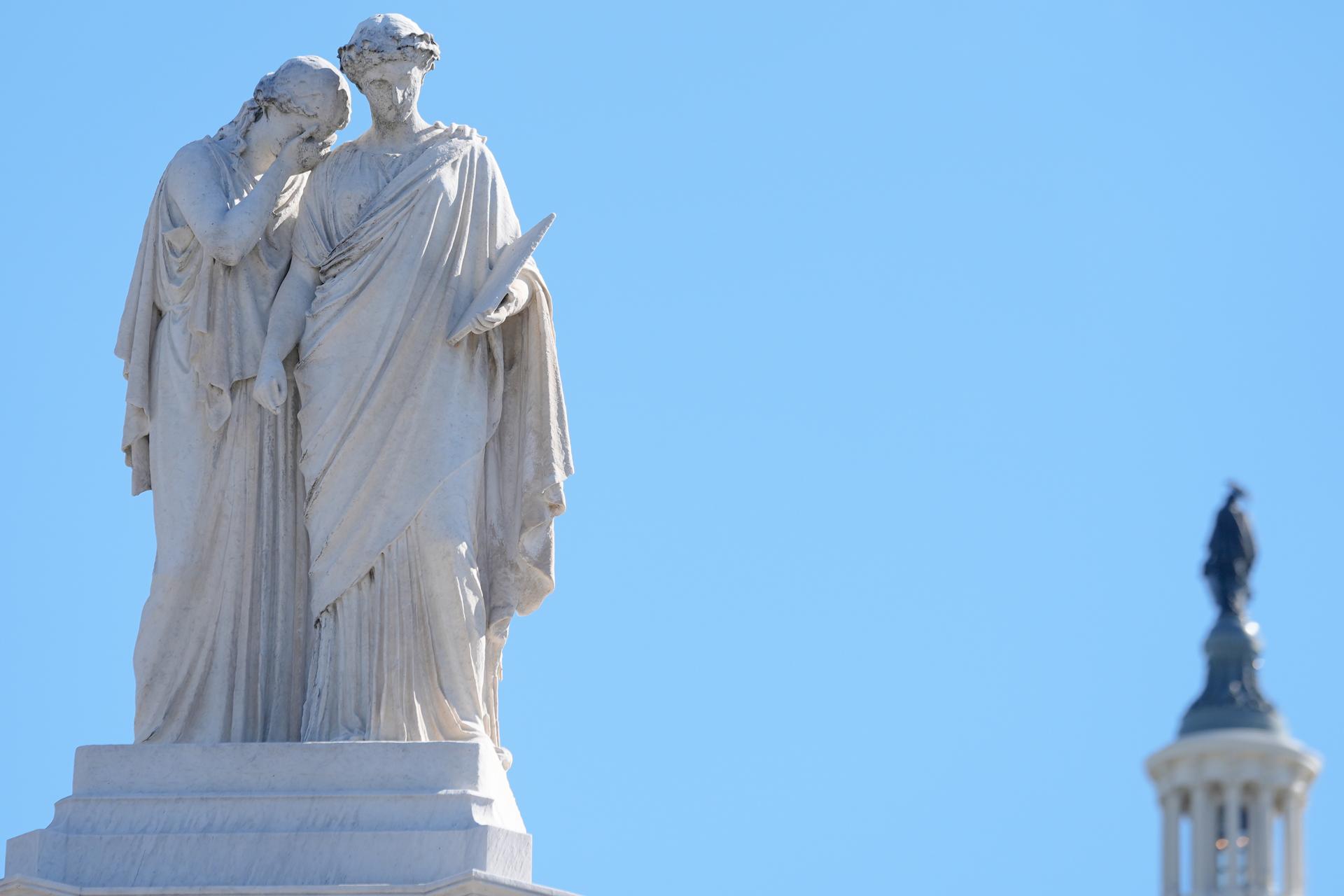 The Statue of Peace looks on as the statue of Freedom is visible in the background in Washington on Thursday. (AP Photo/Mariam Zuhaib)