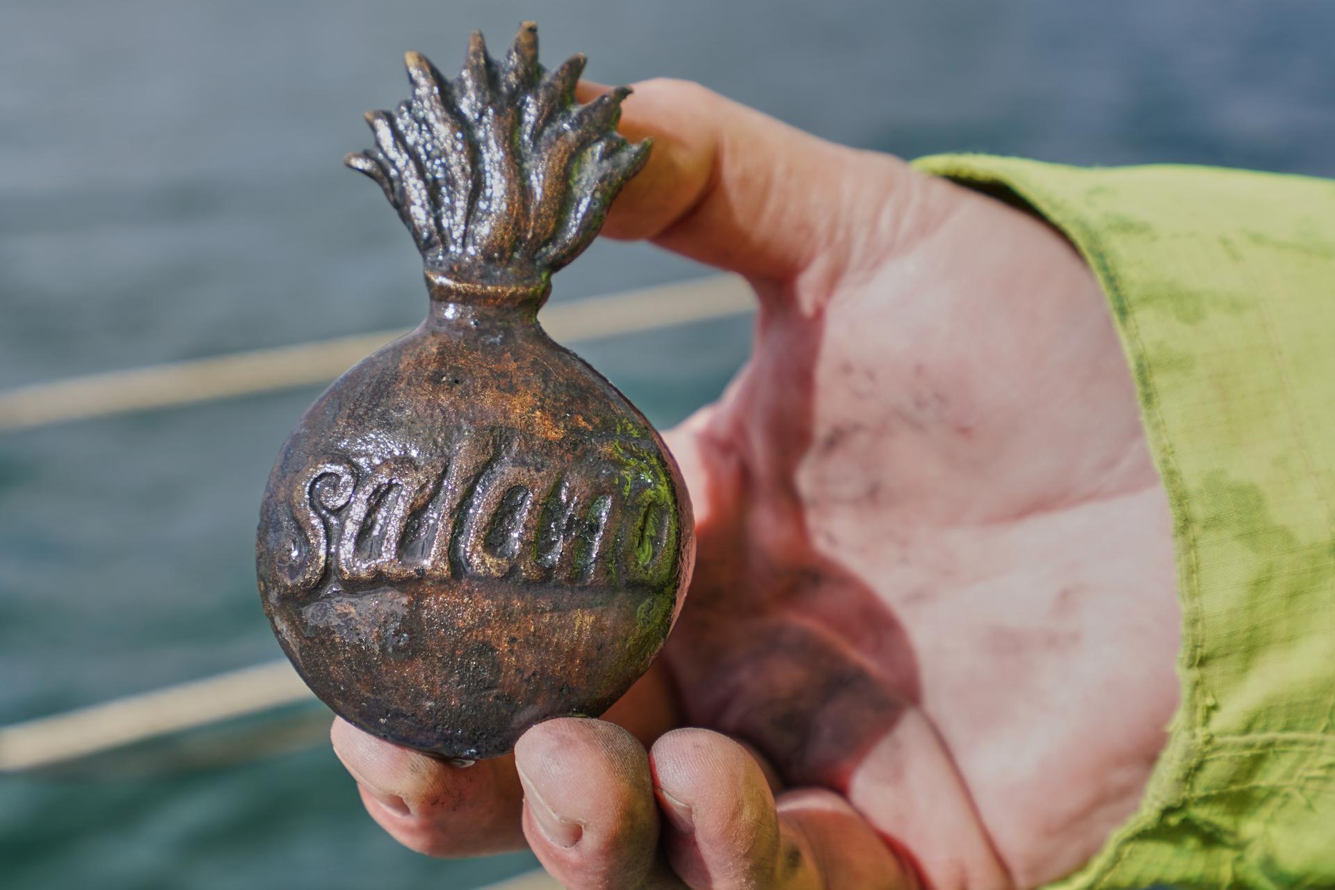Morten Johansen, head of maritime archaeology at Denmark's Viking Ship Museum, shows a metal insignia recovered from the wreck of Danish flagship 