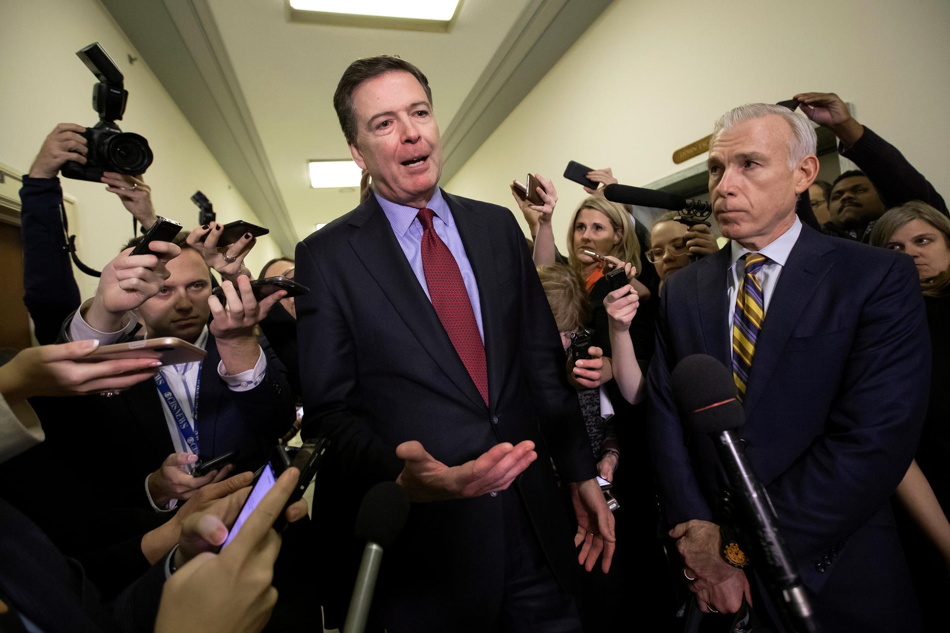 Former FBI Director James Comey, with his attorney, David Kelley, right, speaks to reporters after a day of testimony on Capitol Hill in 2018. (AP Photo/J. Scott Applewhite)