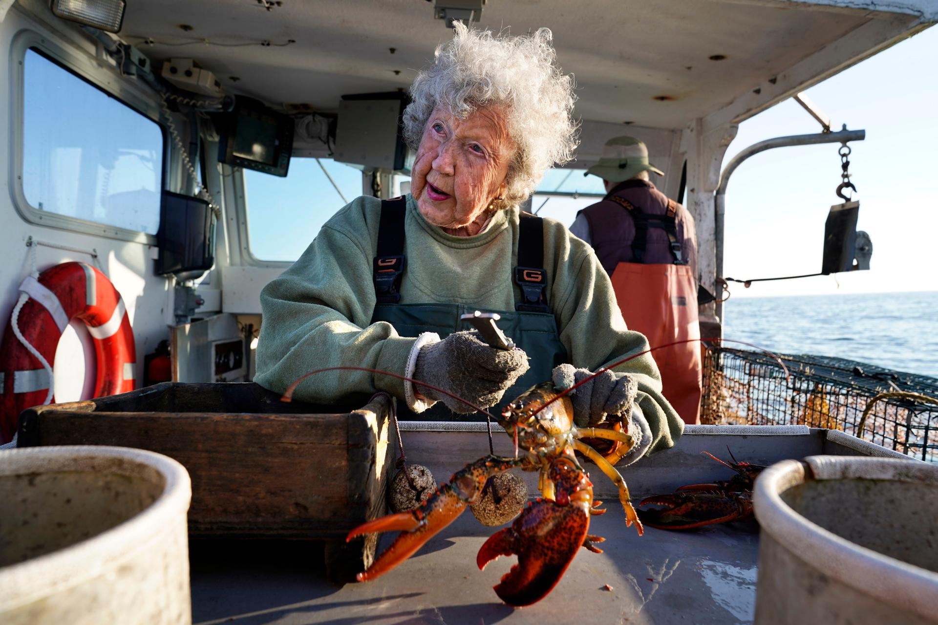 Virginia Oliver works on her son’s boat off Rockland, Maine, in 2021. (AP Photo/Robert F. Bukaty)