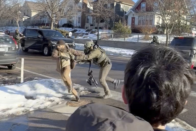 This image taken from video by Max Shapiro shows Alex Pretti, left, scuffling with federal immigration officers in Minneapolis on Jan. 13, 2026.