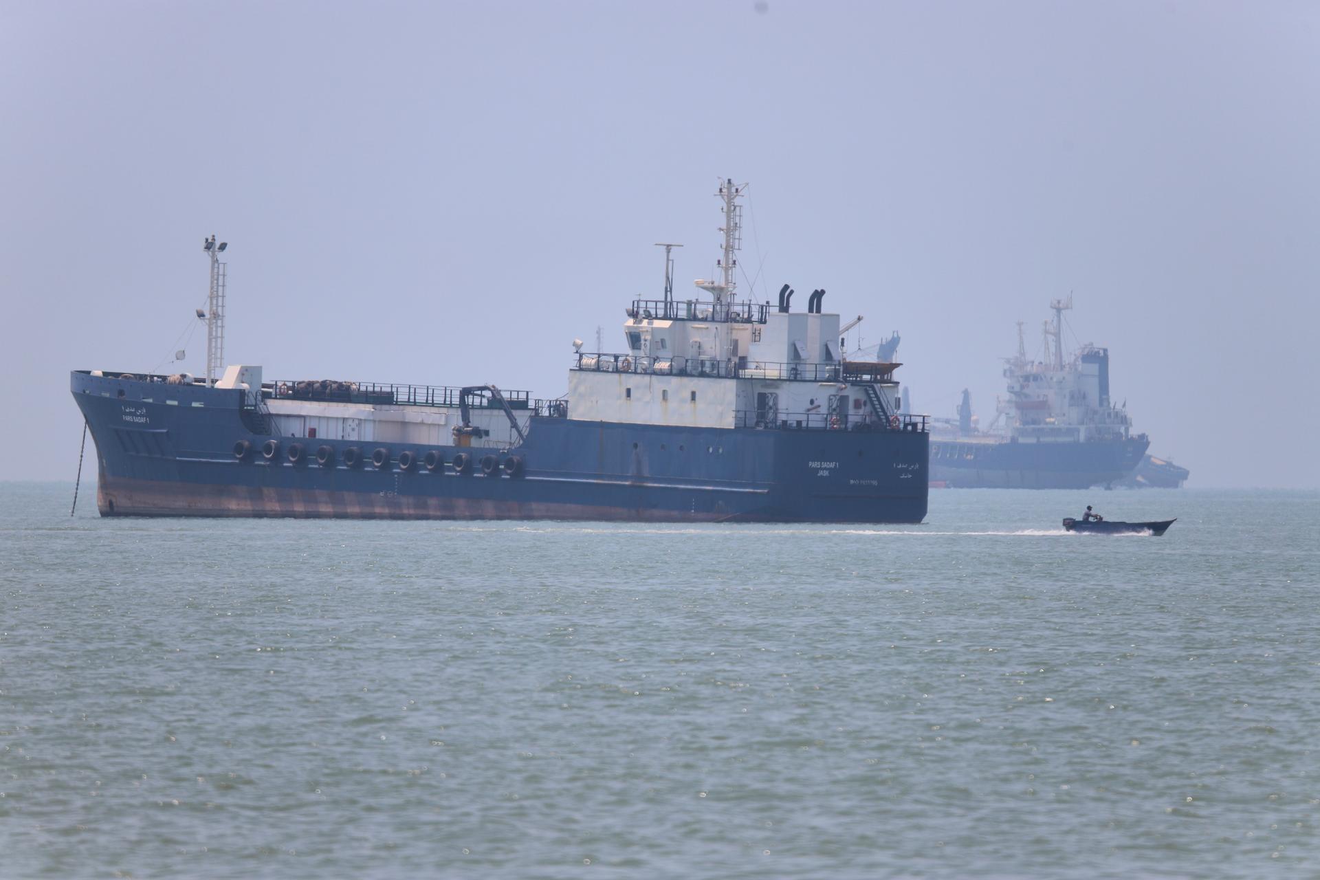 A small motorboat passes anchored vessels in the Strait of Hormuz off Bandar Abbas, Iran, Wednesday. 