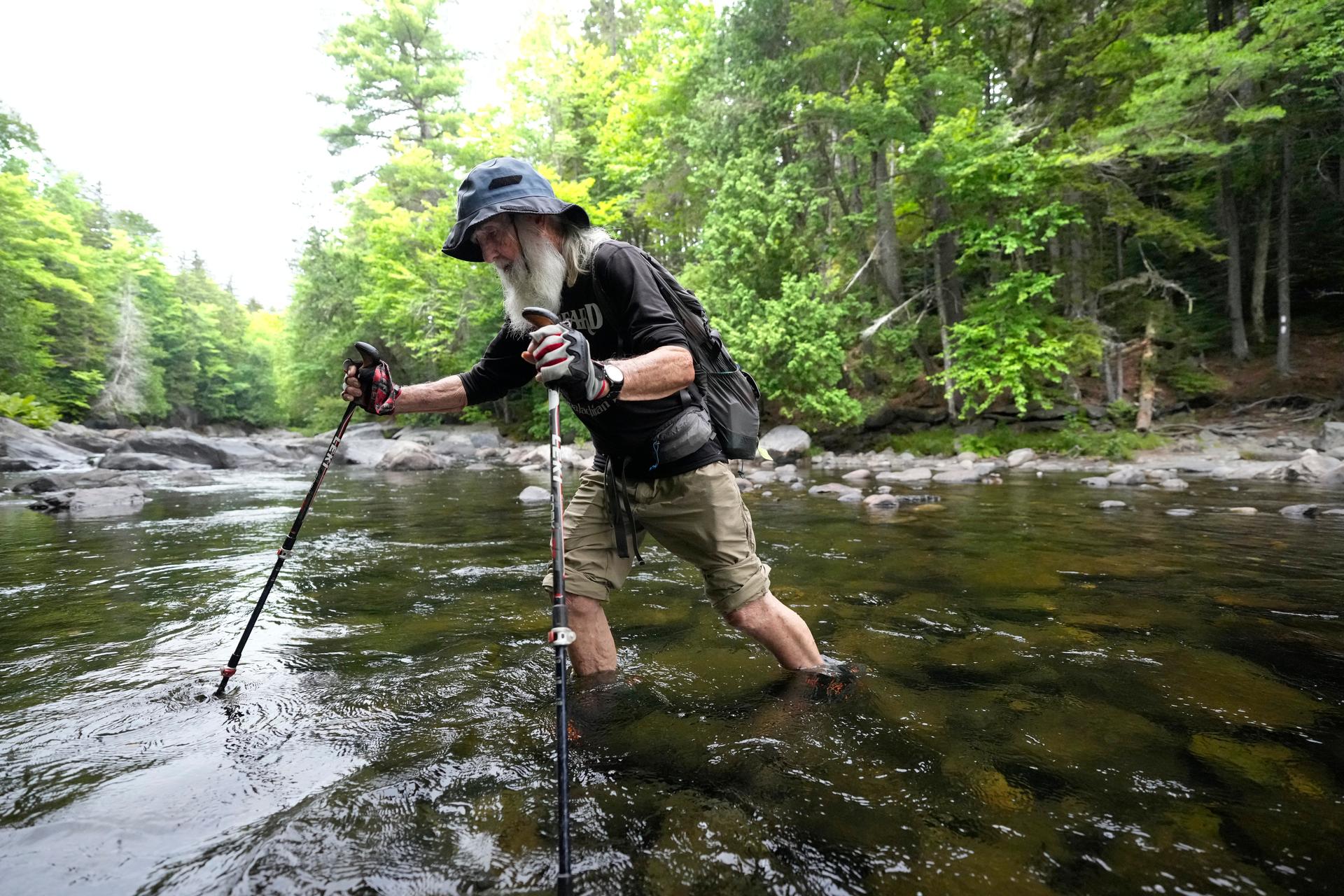 Dale Sanders wades across Big Wilson Stream on the 100-Mile Wilderness north of Monson, Maine, July 29.