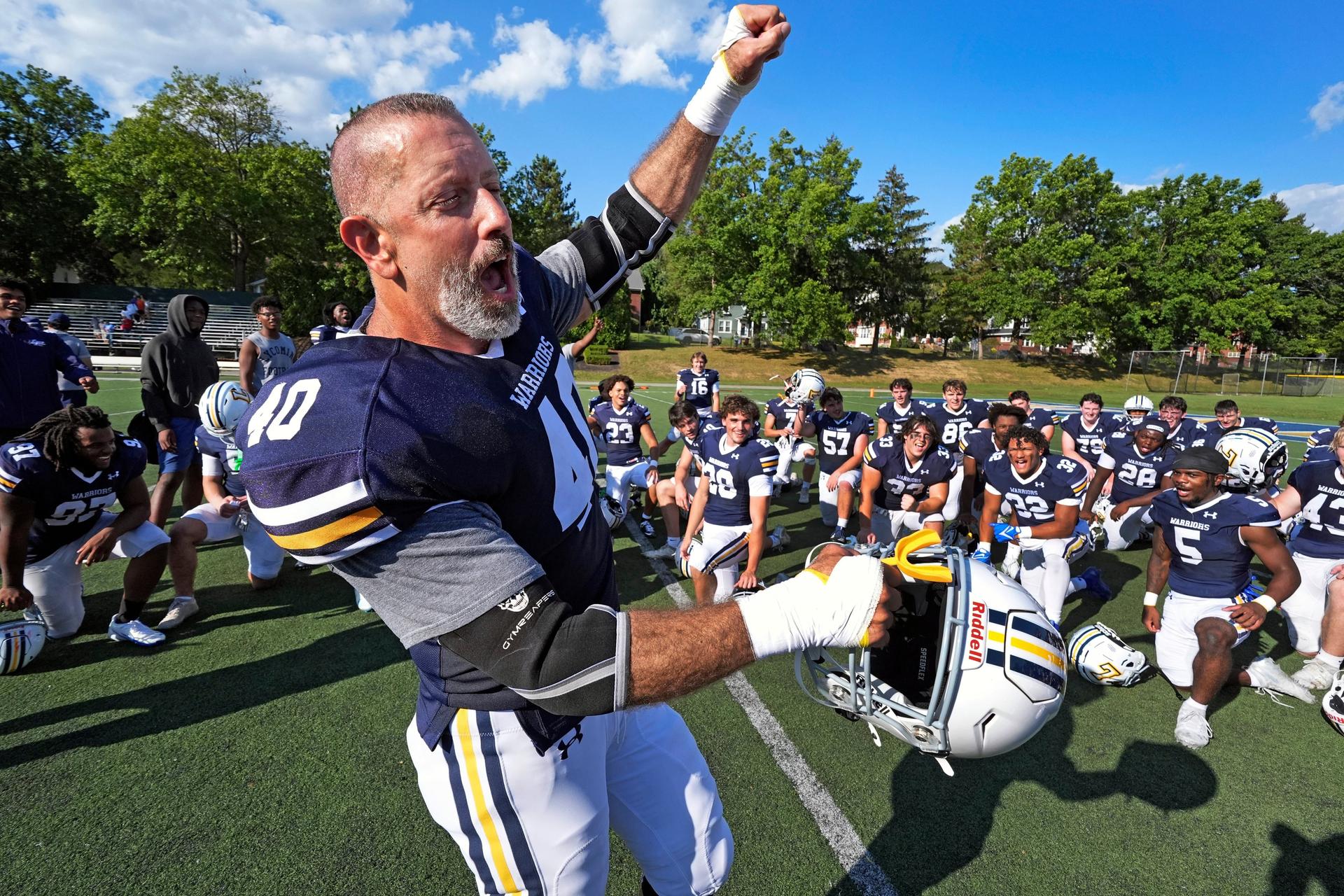 Tom Cillo and teammates celebrate a win over King's College in an NCAA Division III junior varsity college football game in Williamsport, Pa., Sept. 28.