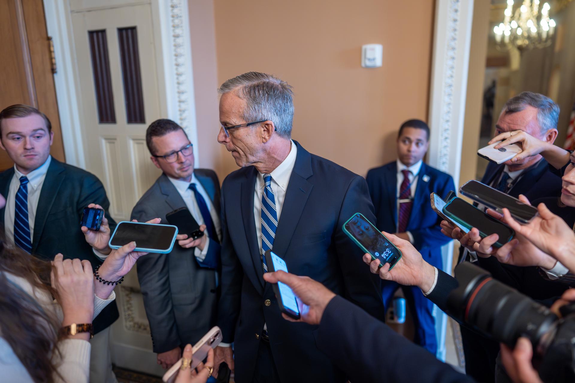 Senate Majority Leader John Thune, R-S.D., heads to a closed-door GOP meeting at the Capitol on Friday. (AP Photo/J. Scott Applewhite)