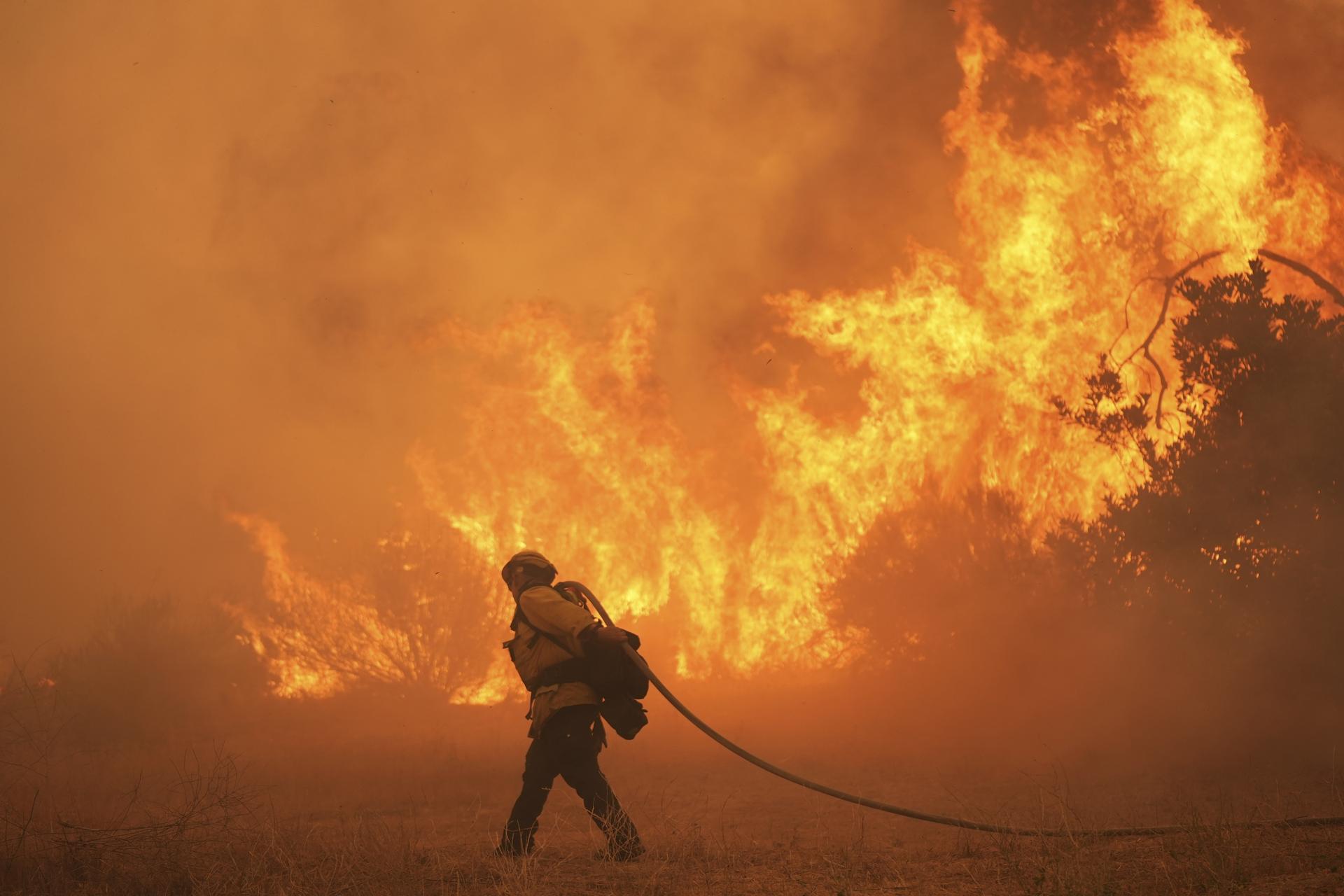 A firefighter battles the Canyon Fire on Aug. 7 in Hasley Canyon, Calif. (AP Photo/Marcio Jose Sanchez)