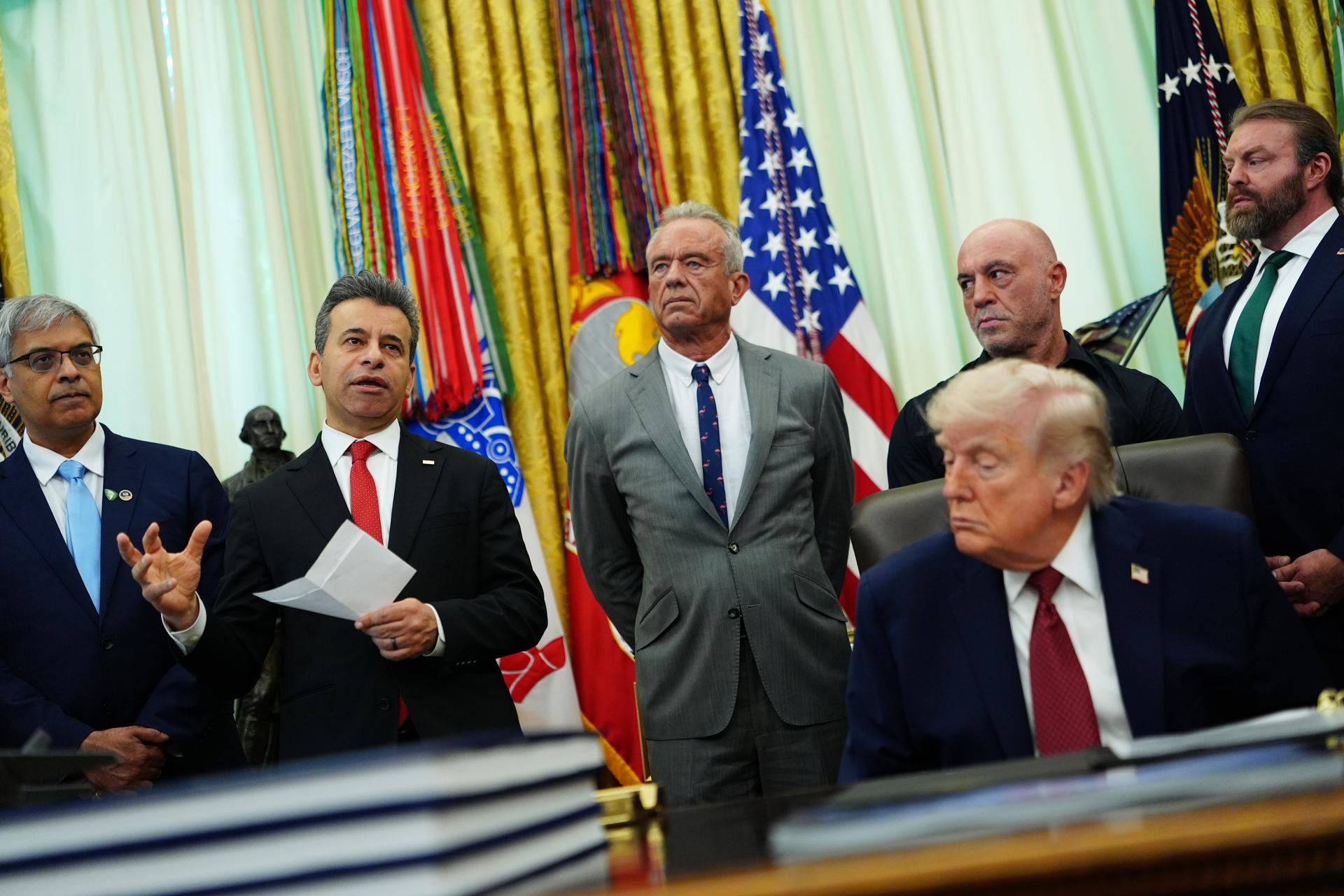Dr. Marty Makary, commissioner of the Food and Drug Administration, speaks while, from left, National Institutes of Health Director Dr. Jay Bhattacharya, Health and Human Services Secretary Robert F. Kennedy Jr., President Donald Trump, Joe Rogan and CEO of Americans for Ibogaine W. Bryan Hubbard listen in the Oval Office in April. (AP Photo/Julia Demaree Nikhinson)