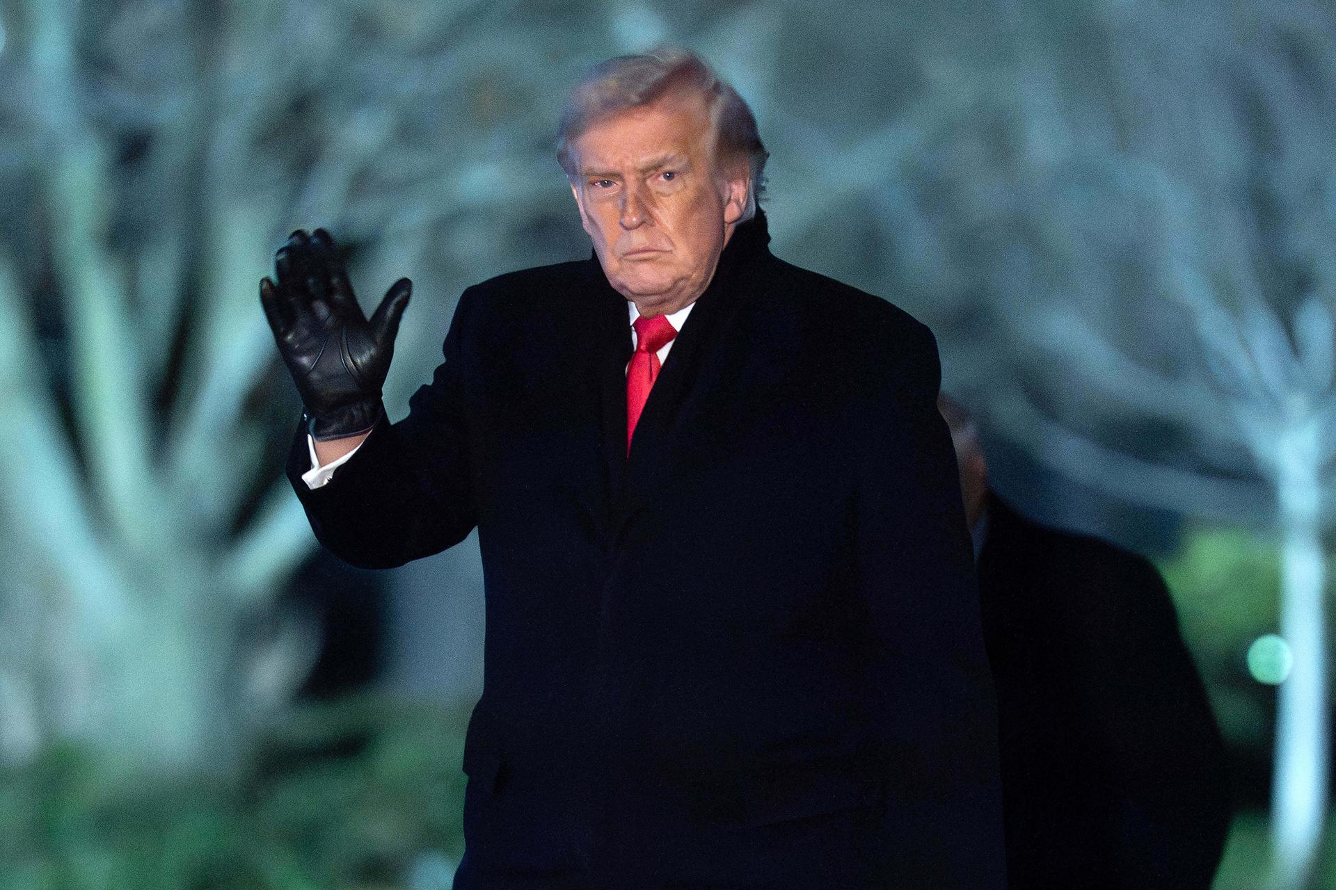 President Donald Trump waves to the media as he walks on the South Lawn of the White House, Tuesday, in Washington.