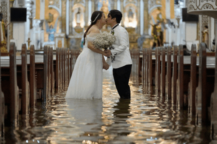 A GIF of newlyweds celebrating their wedding at a flooded church in the Philippines.  (AP Photos/Aaron Favila).