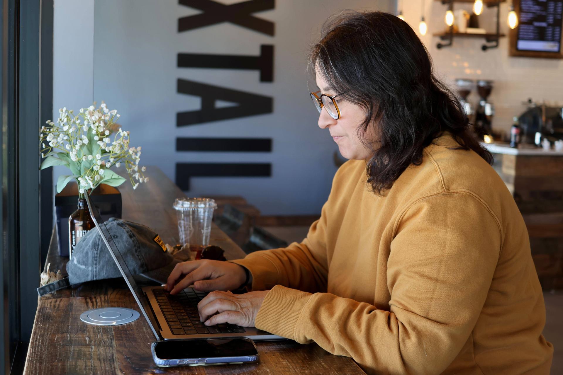 Lauren Contreras works from her laptop at Foxtail Coffee Co., in Flagstaff, Ariz., April 20.
