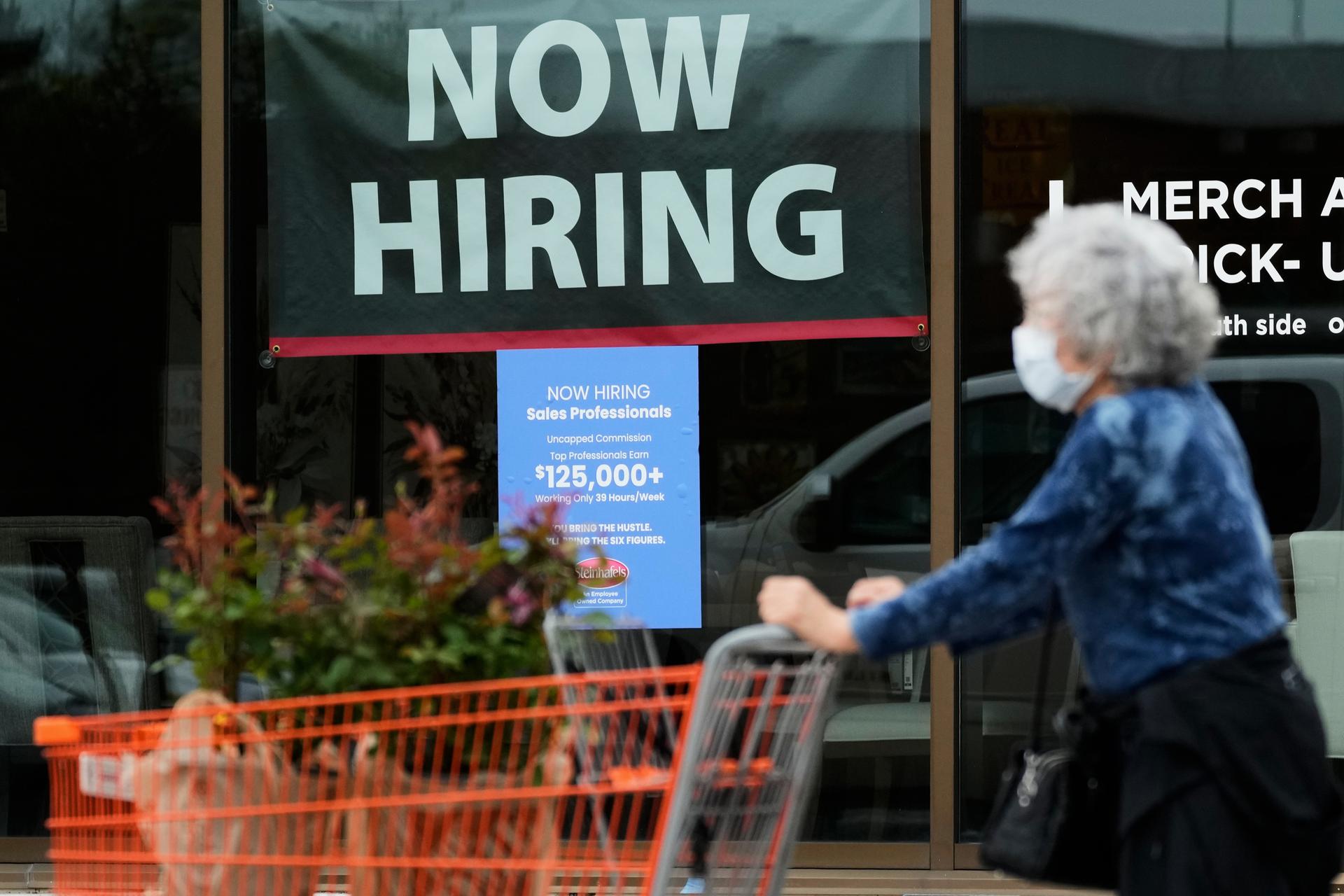 Hiring sign for sales professionals is displayed at a store in Vernon Hills, Ill. on April 15.