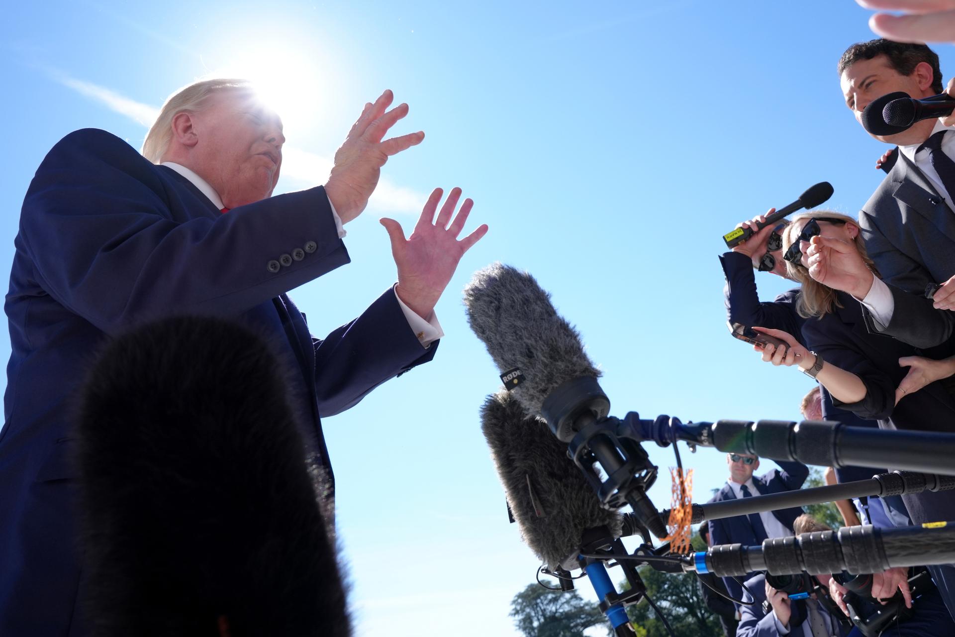 President Donald Trump speaks with reporters before boarding Marine One on the South Lawn of the White House, Thursday, in Washington.