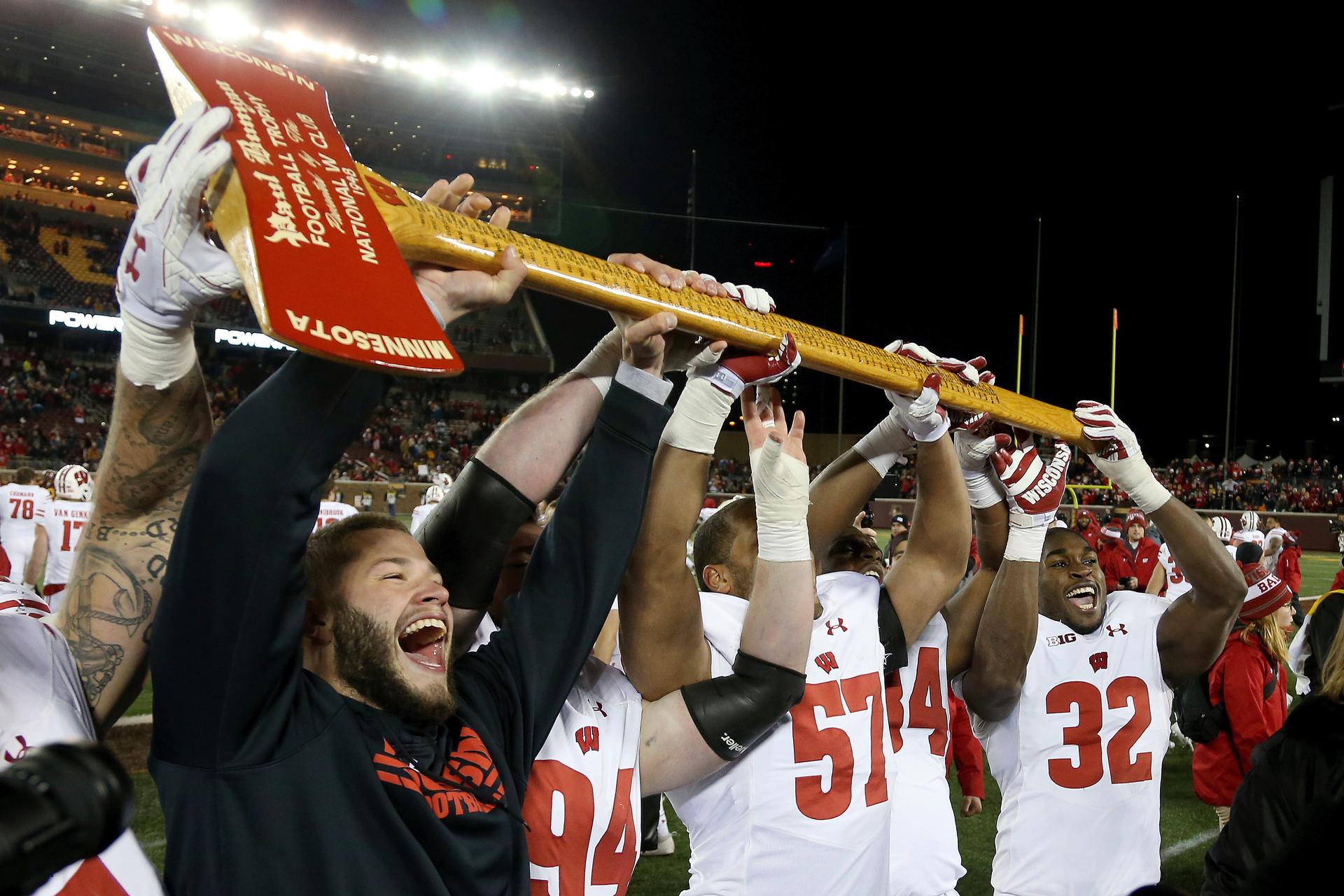 In this 2017, file photo, Wisconsin players hold up Paul Bunyan's Axe up after winning 31-0 against Minnesota in an NCAA college football game in Minneapolis. (AP Photo/Stacy Bengs, File)