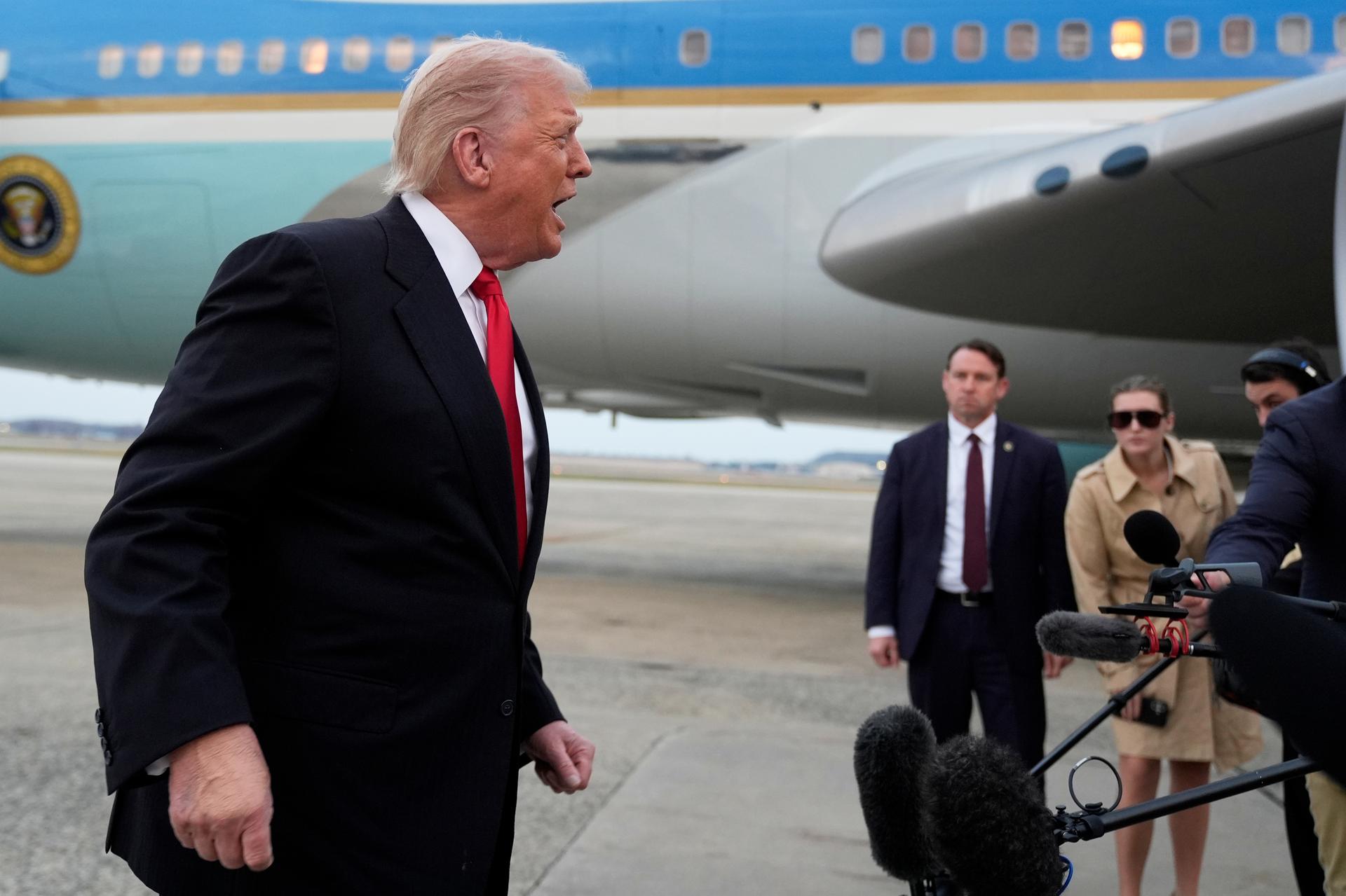 President Donald Trump speaks with reporters upon arriving on Air Force One at Joint Base Andrews, Md., Sunday, Nov. 9, 2025.