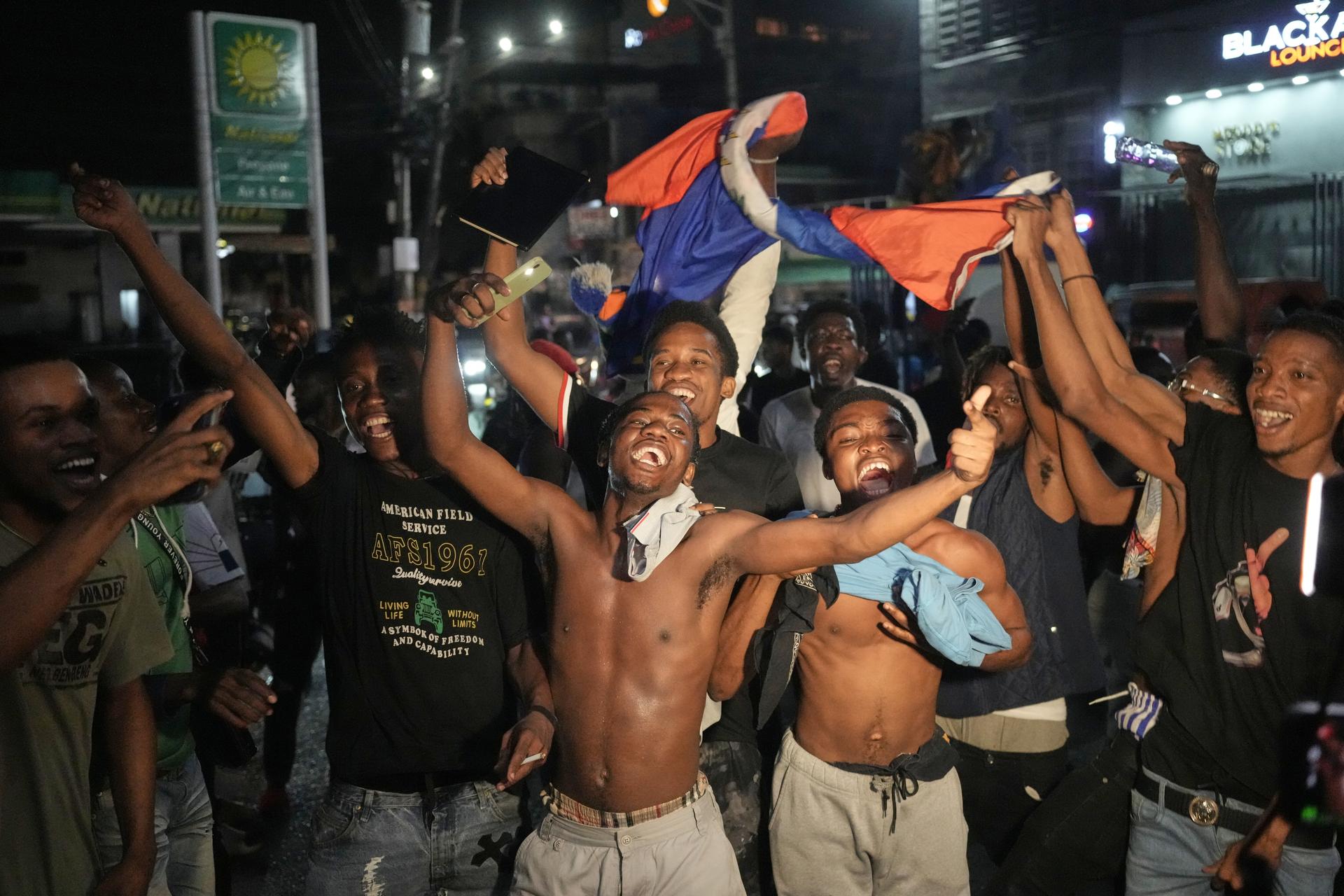 Fans celebrate Haiti's qualification for the 2026 FIFA World Cup after a soccer match against Nicaragua on Tuesday. (AP Photo/Odelyn Joseph)