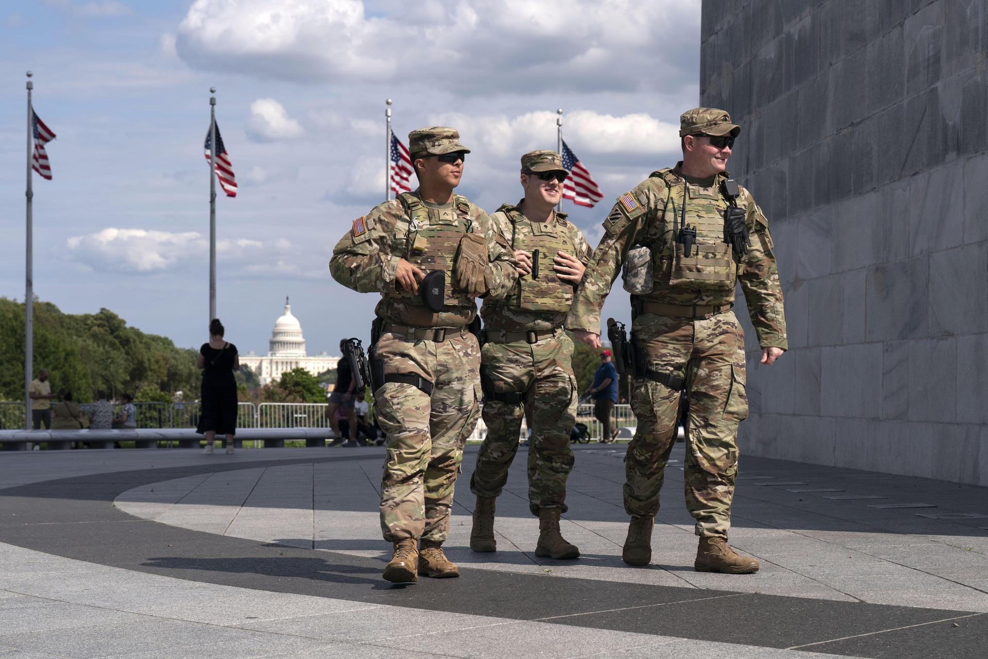 Members of the Louisiana National Guard patrol the grounds of the Washington Monument at the National Mall on Sunday in Washington. (AP Photo/Jose Luis Magana).