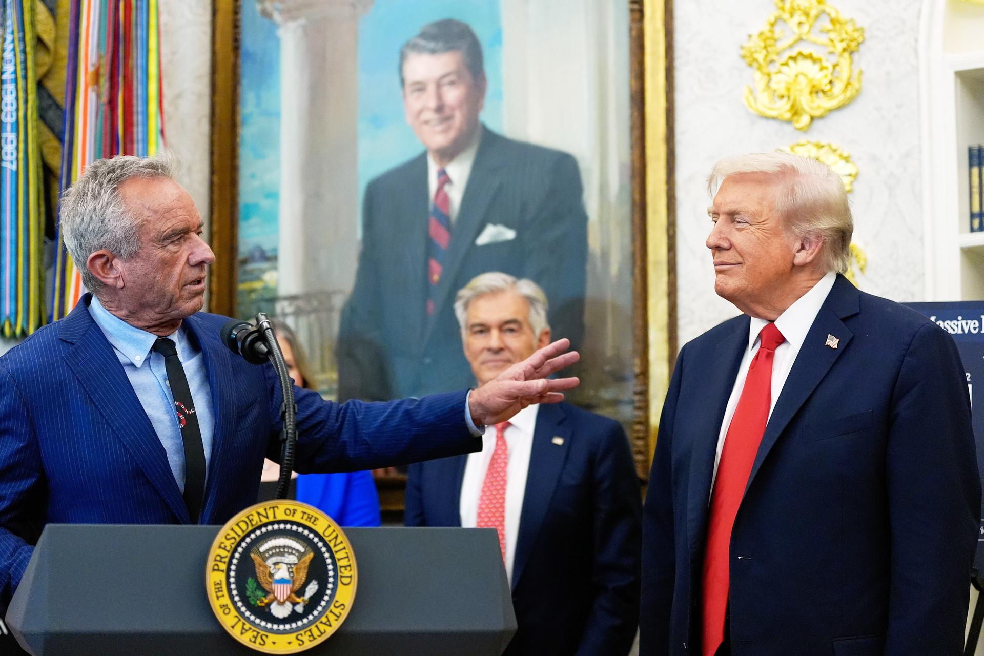 President Donald Trump listens as Health and Human Services Secretary Robert F. Kennedy Jr., speaks in the Oval Office of the White House, Oct. 16, 2025, in Washington. (AP Photo/Alex Brandon, File)