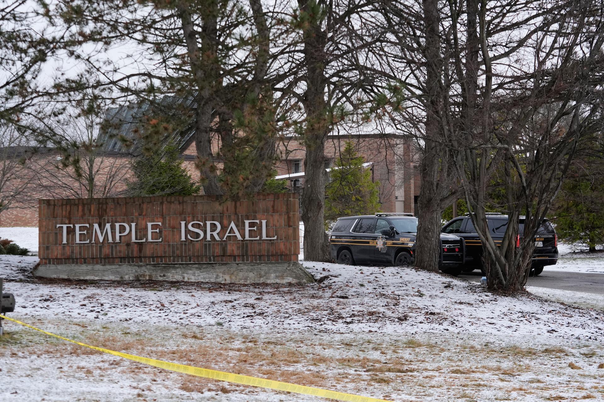 Police tape hangs outside the Temple Israel synagogue Friday, March 13, 2026, in West Bloomfield Township, Mich. (AP Photo/Paul Sancya).