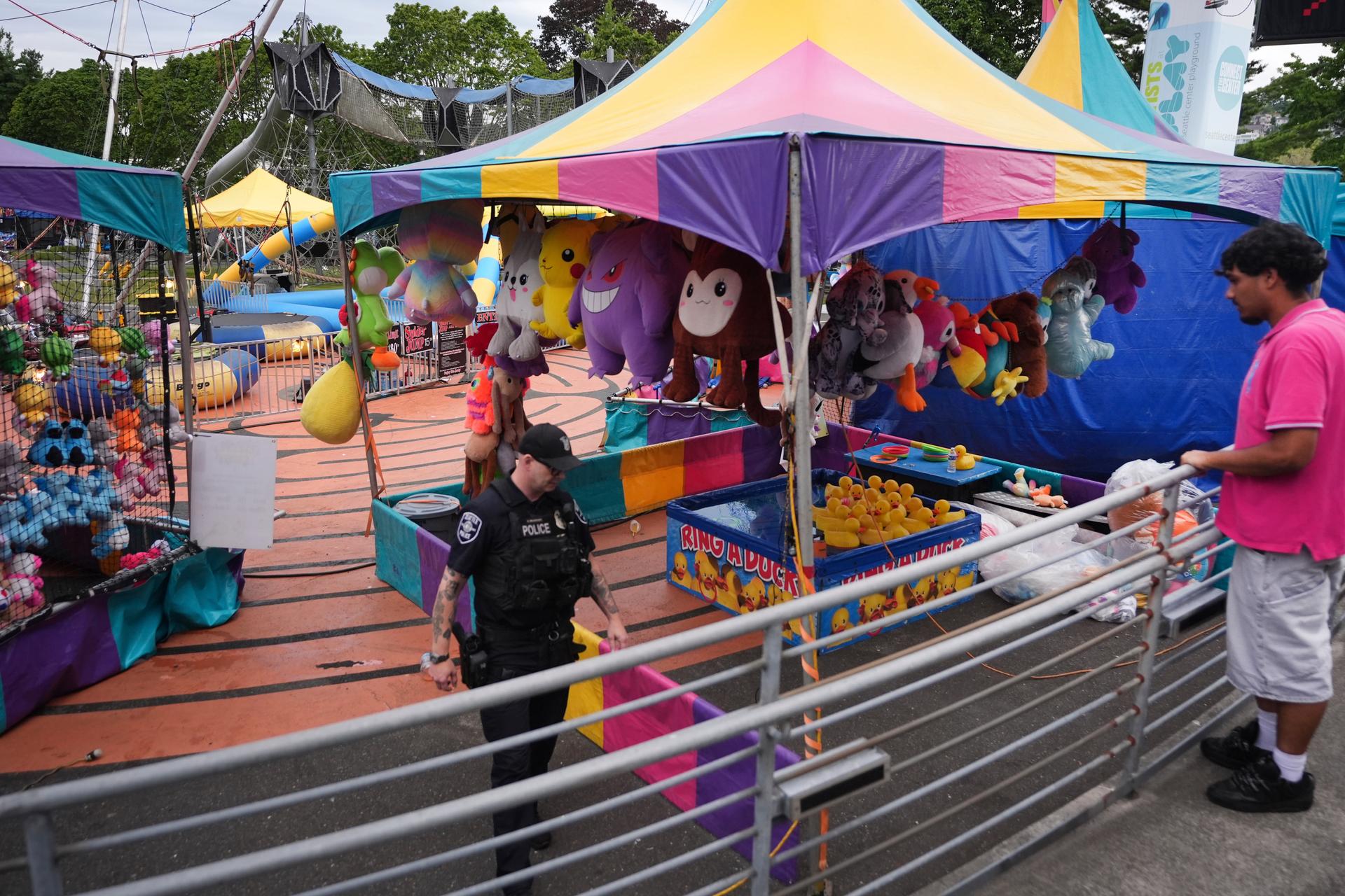 A police officer responds after the shooting at a food festival Sunday, in Seattle, Wash.