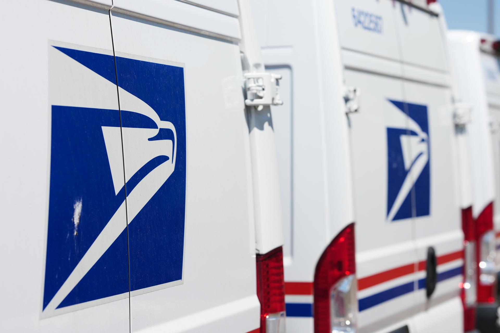 Delivery vans are parked during a protest staged as part of a countrywide National Day of Action, July 28, outside the main United States Postal Service headquarters in northeast Denver.