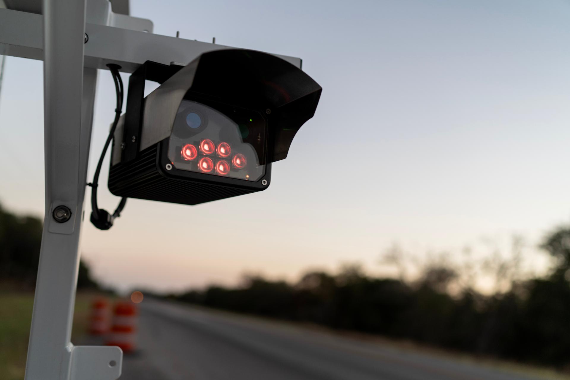 A license plate reader stands along the side of a road, Oct. 15, 2025, in Stockdale, Texas.