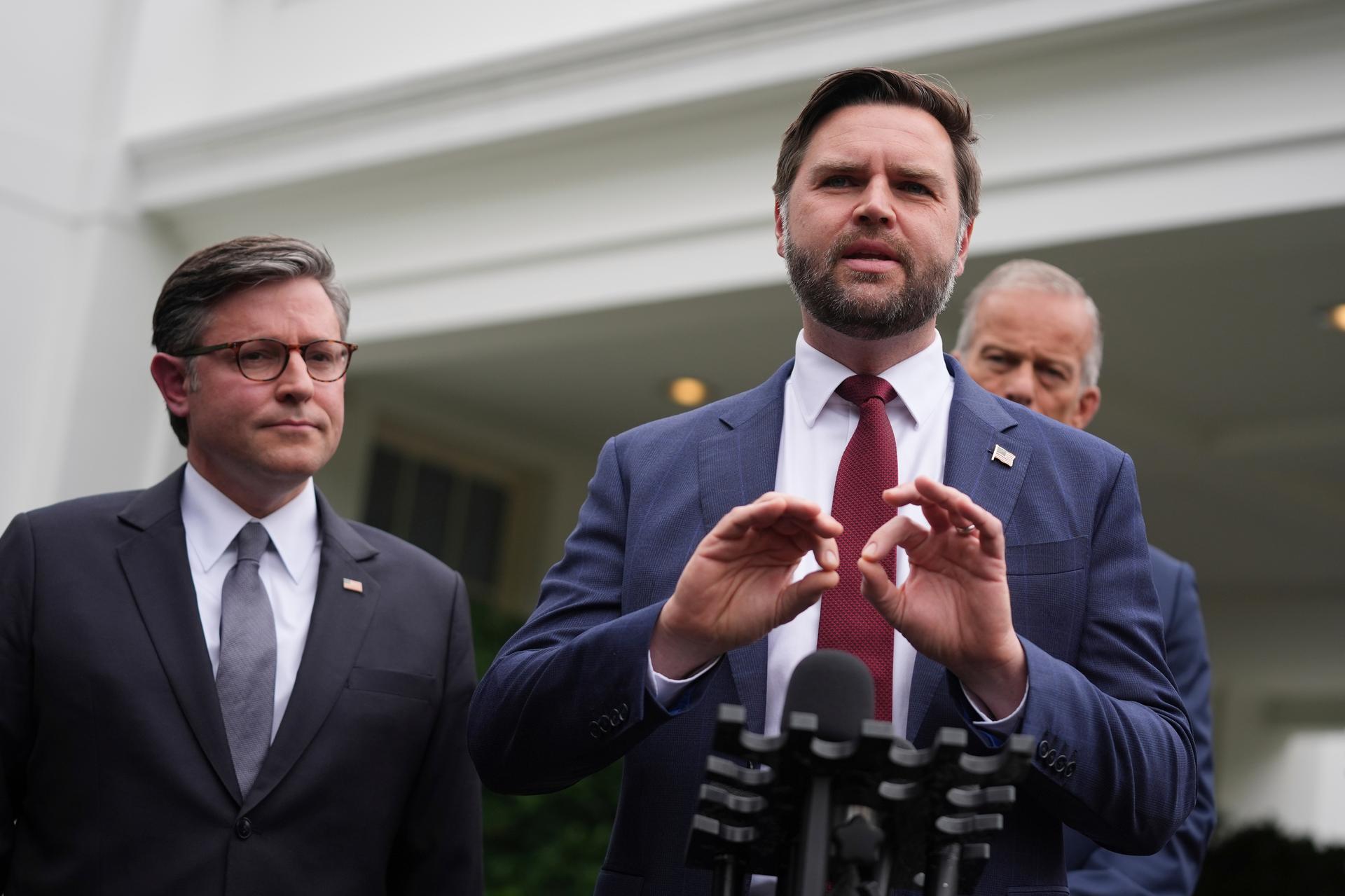 Vice President JD Vance and House Speaker Mike Johnson speak to members of the media outside the West Wing at the White House in Washington, Monday.