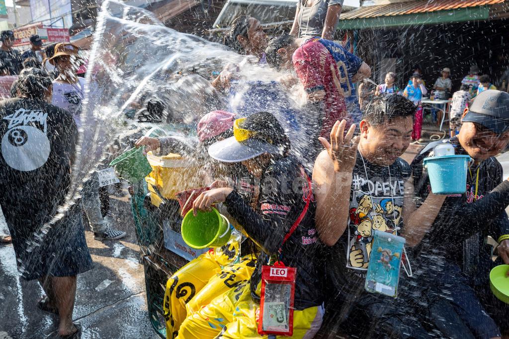 People participate in the Songkran water festival to celebrate the Thai New Year in Prachinburi province, Thailand, Monday.
